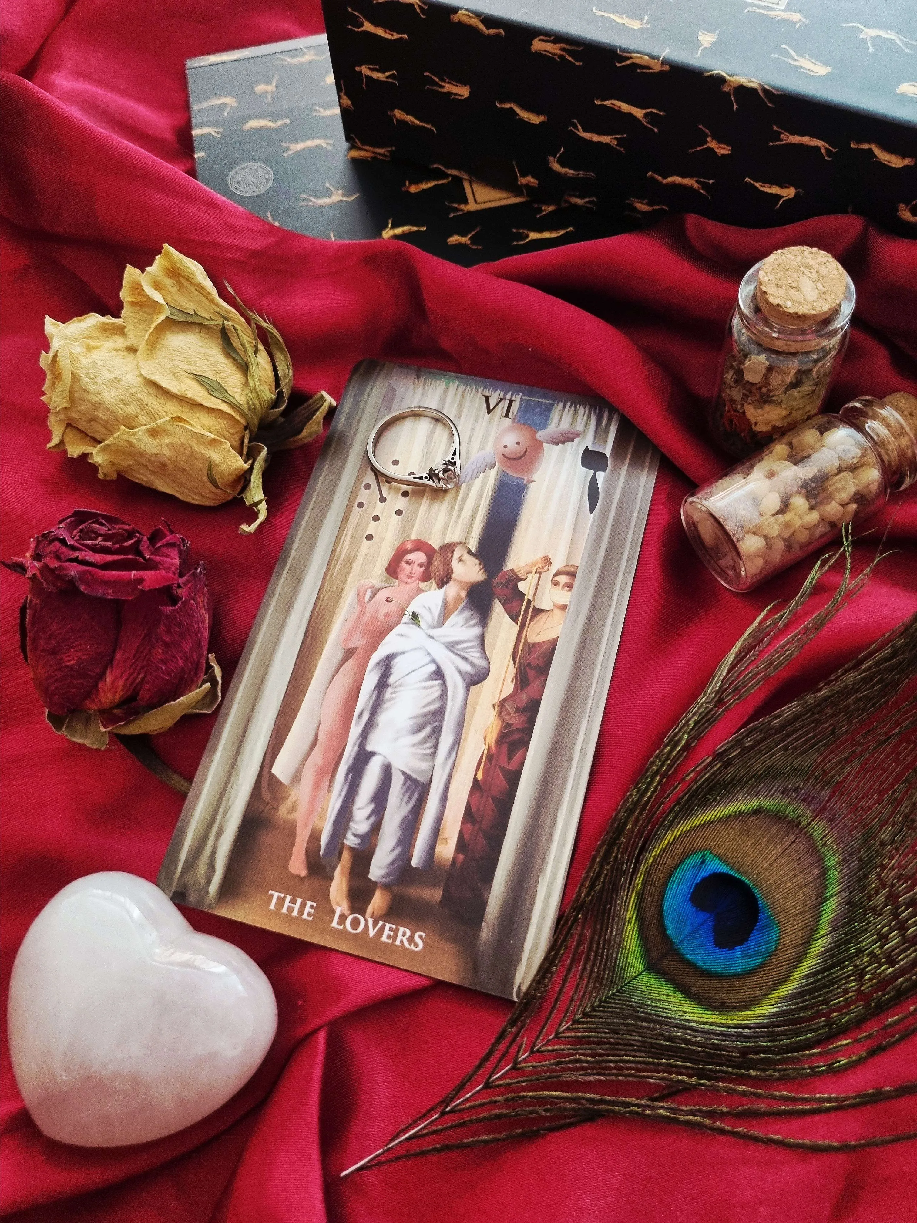 tarot card on a ritual altar with a raven figurine and raw crystals