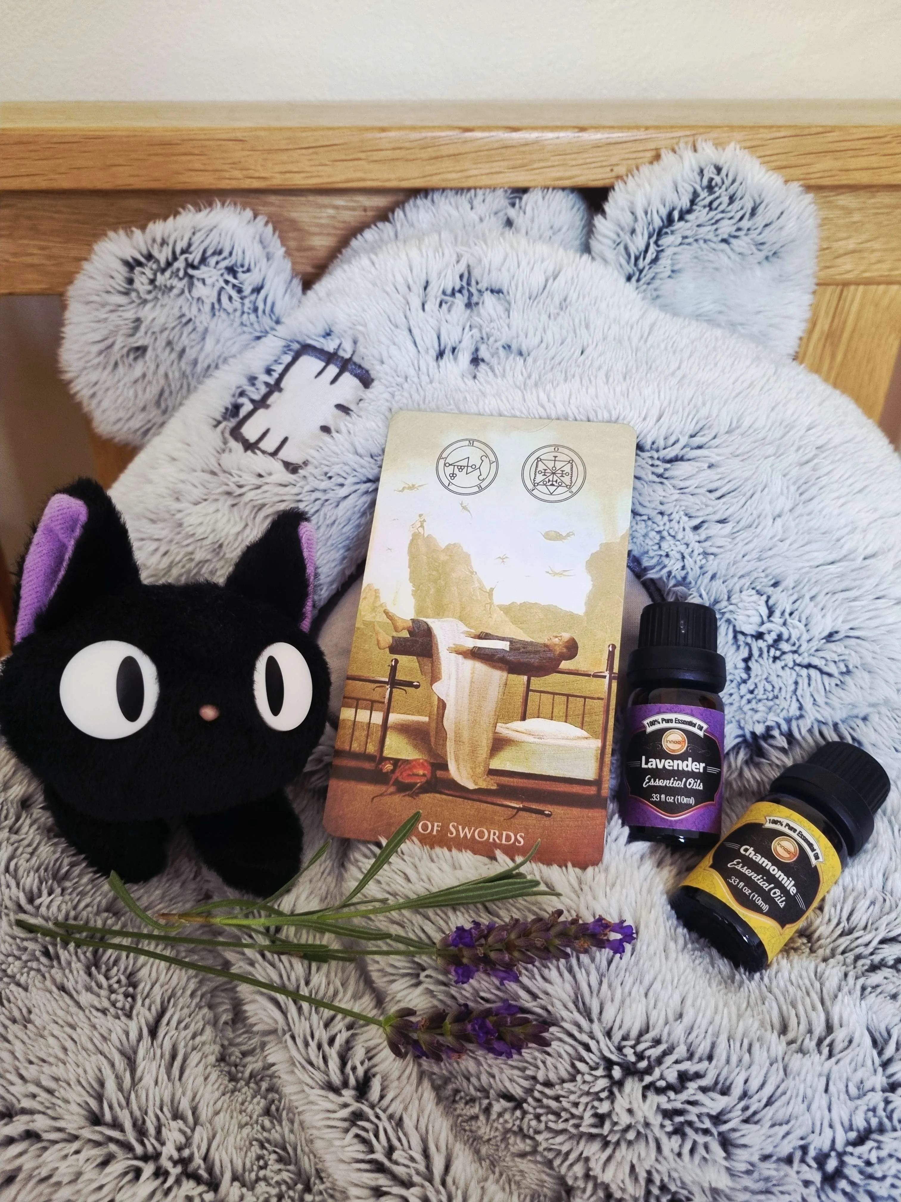 tarot card for dream work beside the bed with lavender and soft toys