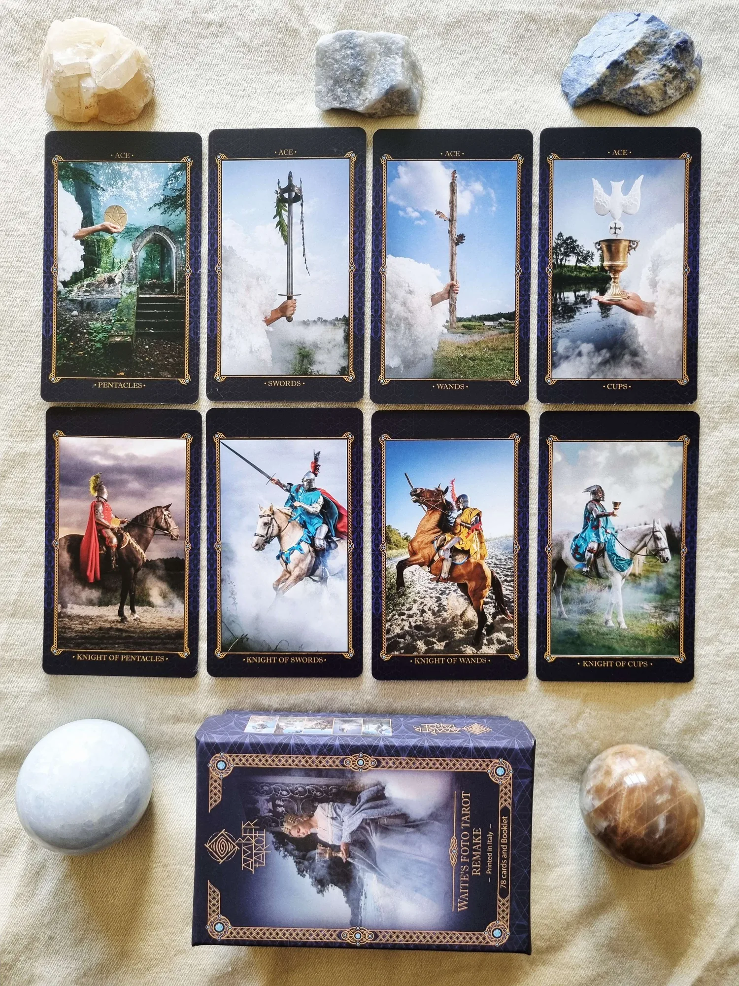 The four Aces and the Knights of Pentacles, Swords, Wands and Cups from Amber Tarot laid out above the deck box, among crystal spheres