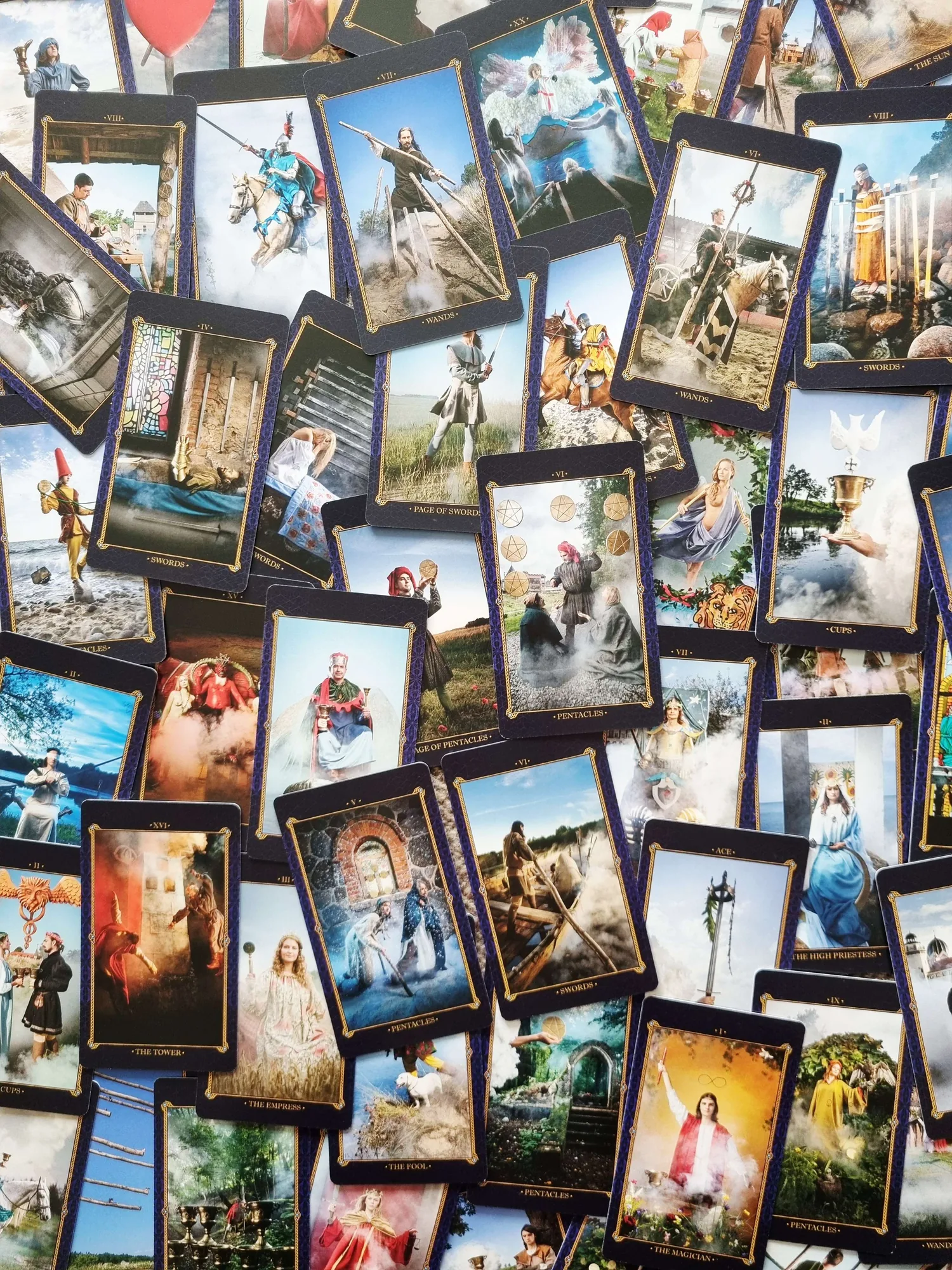 Amber Tarot cards scattered across a table in an overlapping collage of photographed scenes