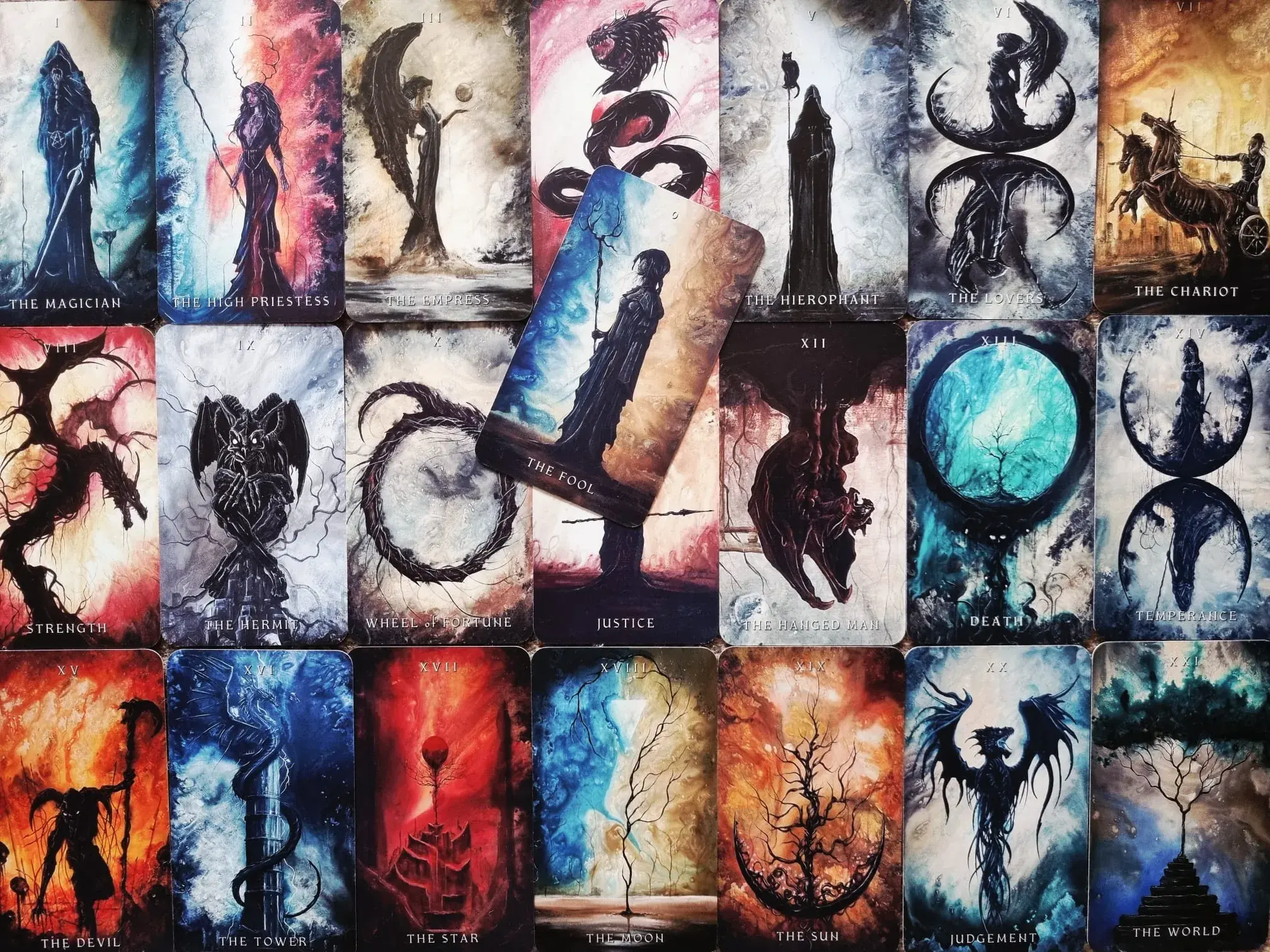 The complete Major Arcana of the Dark Fantasy Tarot laid out in order from The Magician to The World, with The Fool resting on top.