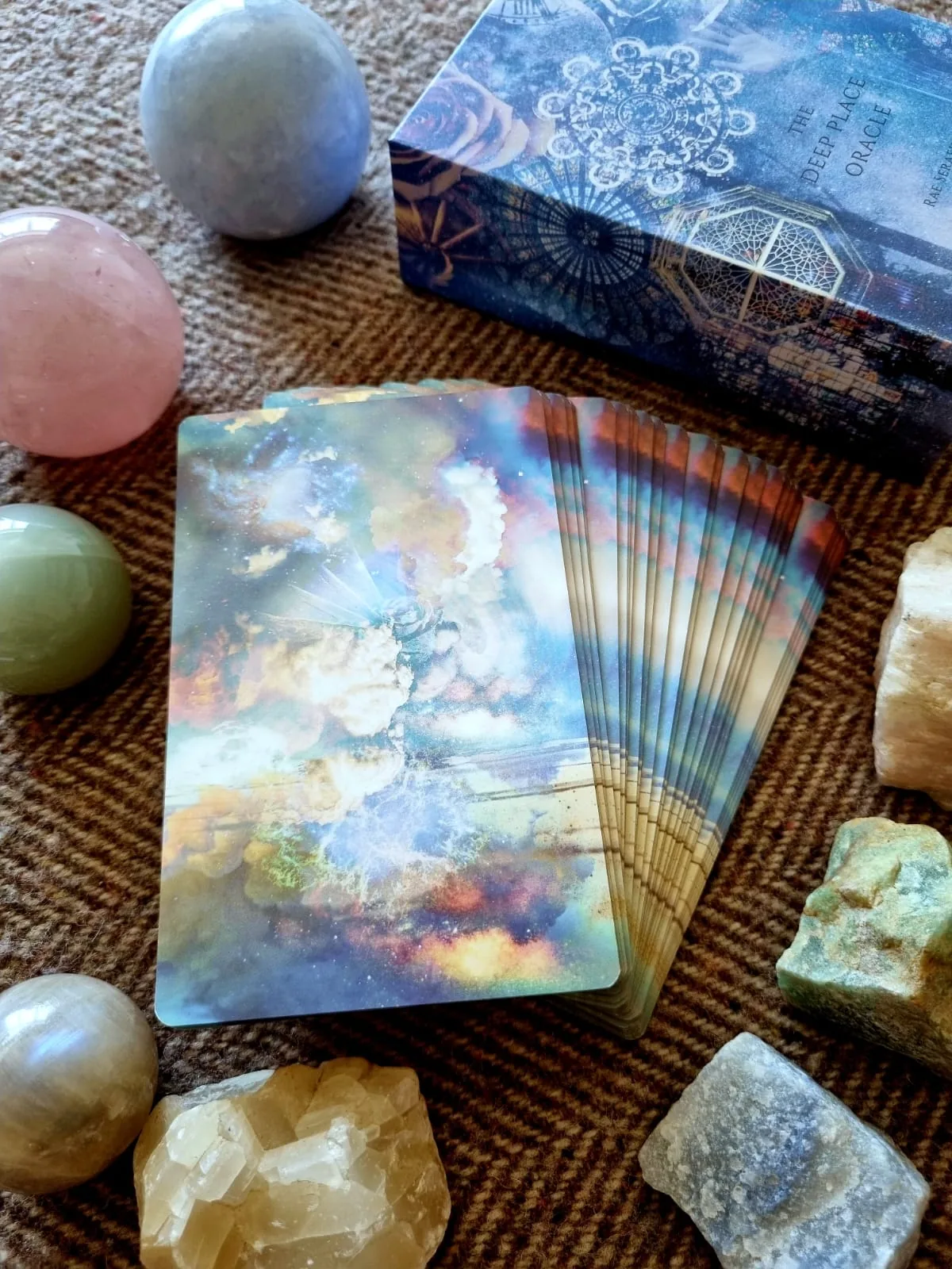 Deep Place Oracle deck fanned beside its box and crystal spheres