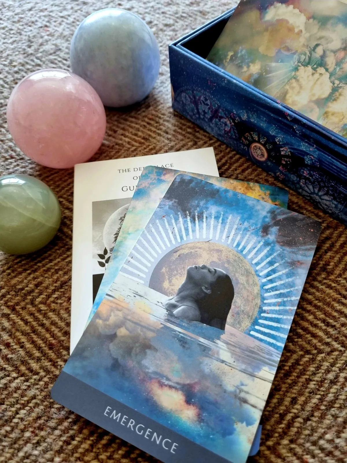 The Deep Place Oracle guidebook open beside the Emergence card