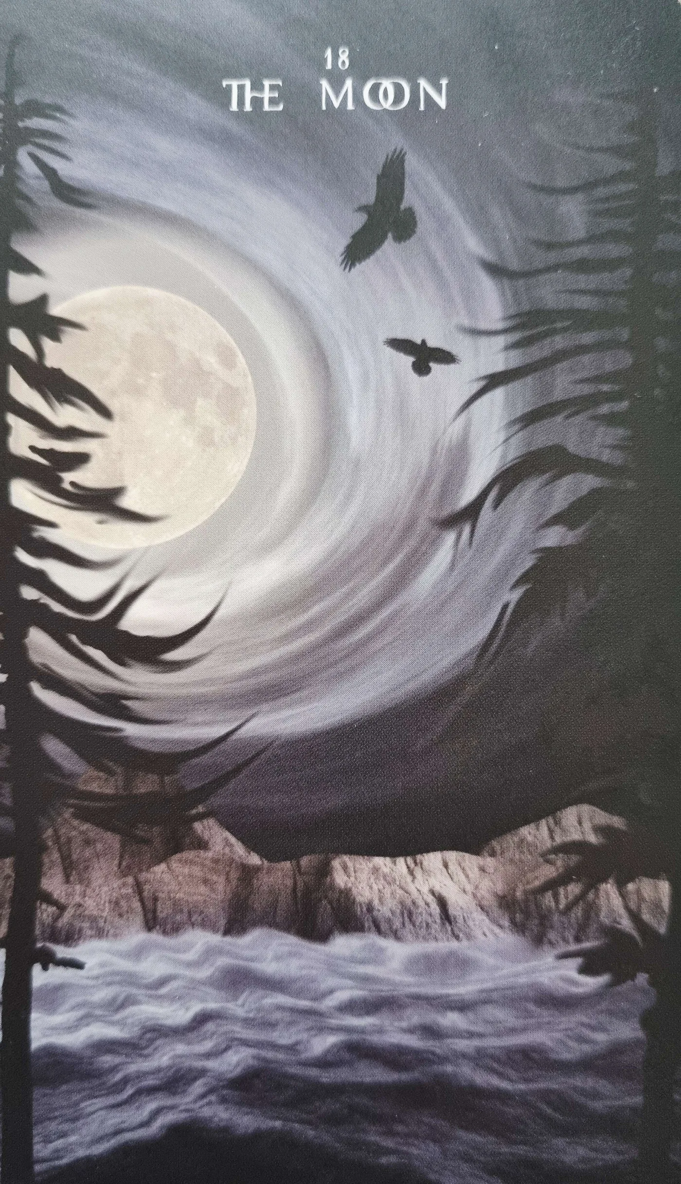 The Moon tarot card with a swirling moonlit sky, illustrating projection