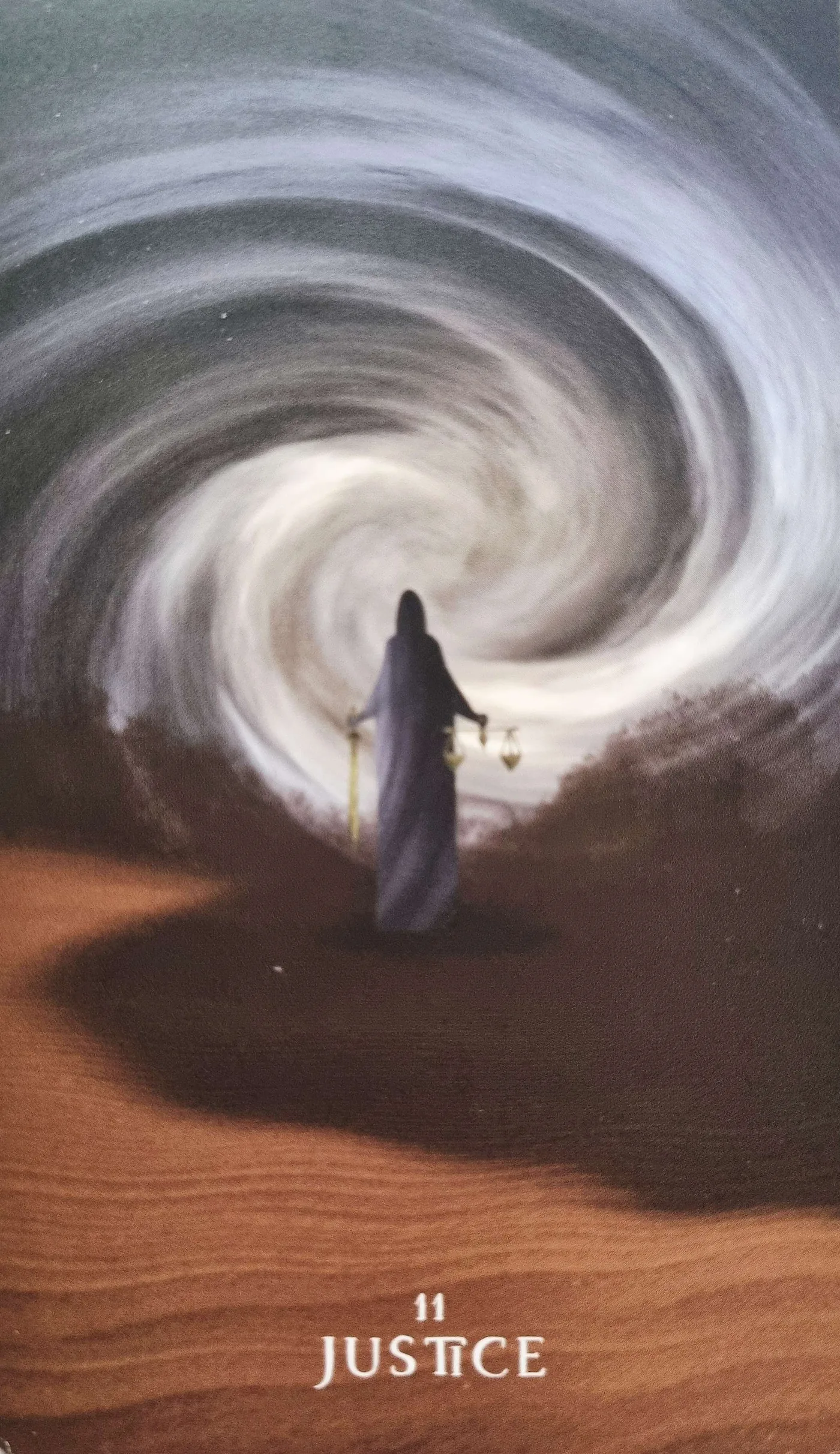 The Justice tarot card, a robed figure walking a winding desert path, illustrating rationalisation