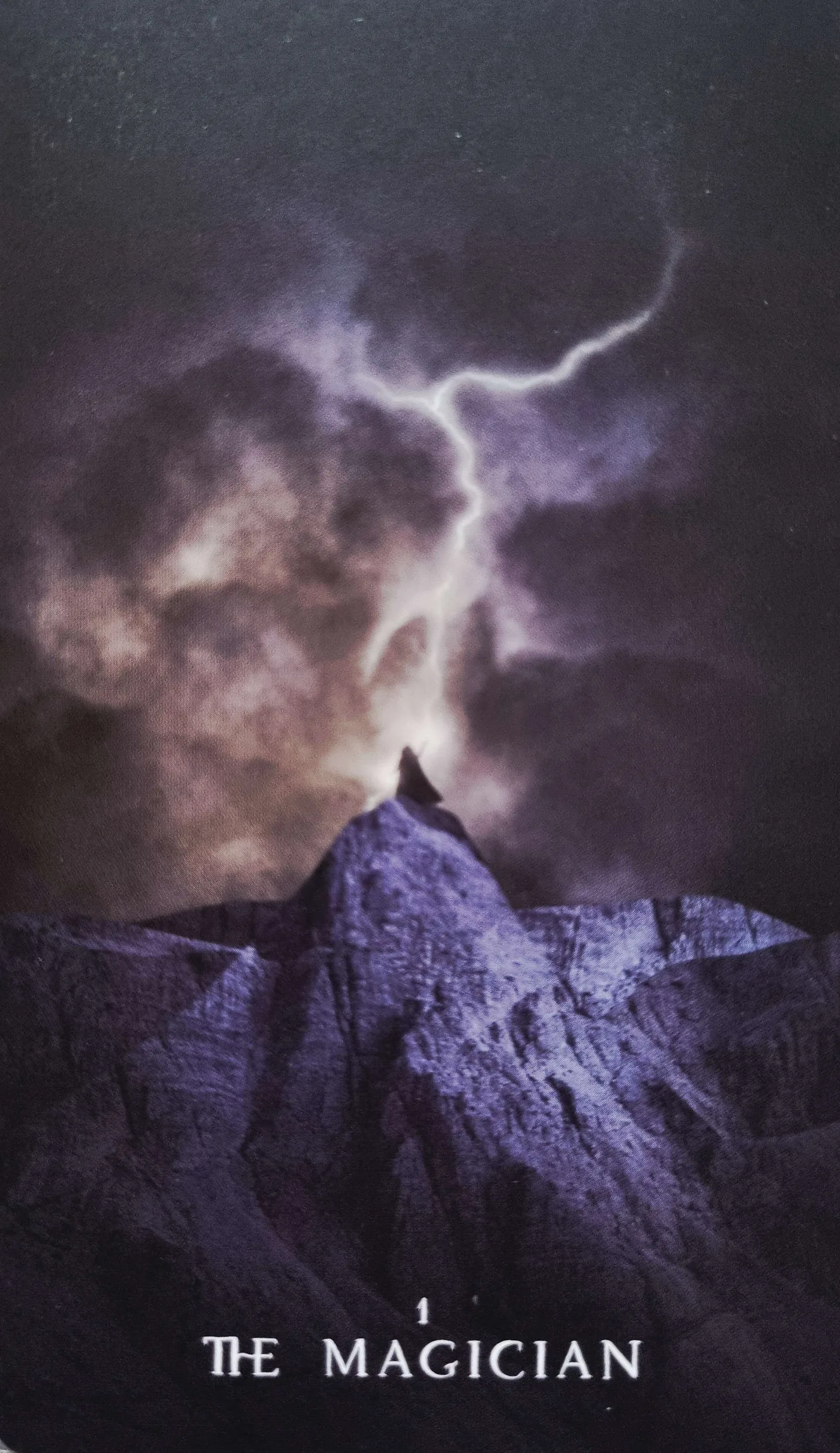 The Magician tarot card with a lightning storm over a mountain, illustrating deflection