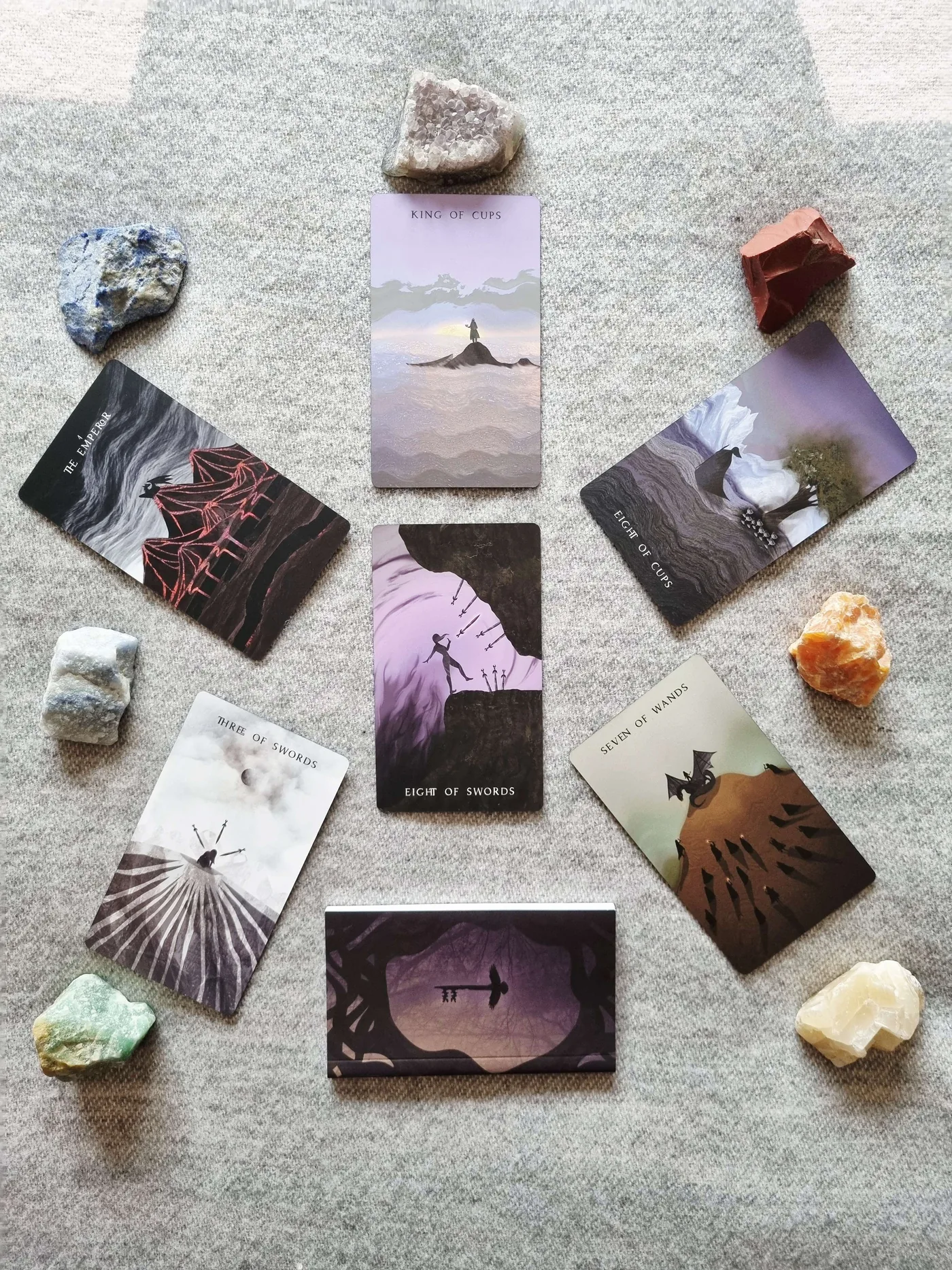 The ego defence tarot spread laid out with the Eight of Swords, King of Cups, Emperor and Seven of Wands and crystals