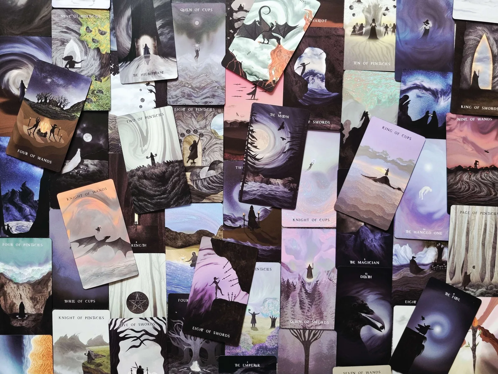 Cards from The Shadows We Cast Tarot by Nicky Ferrada spread out