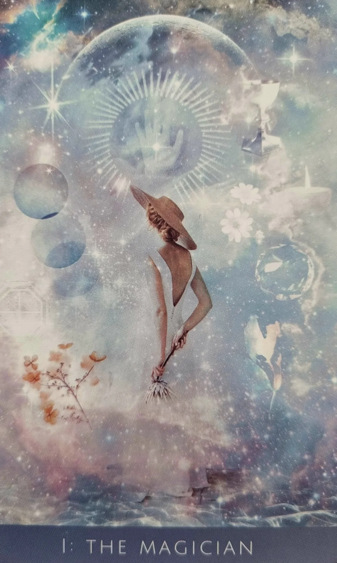 The Magician card from the Rooted Remembrance Tarot, a figure in a sunhat reaching toward a glowing hand within a moon