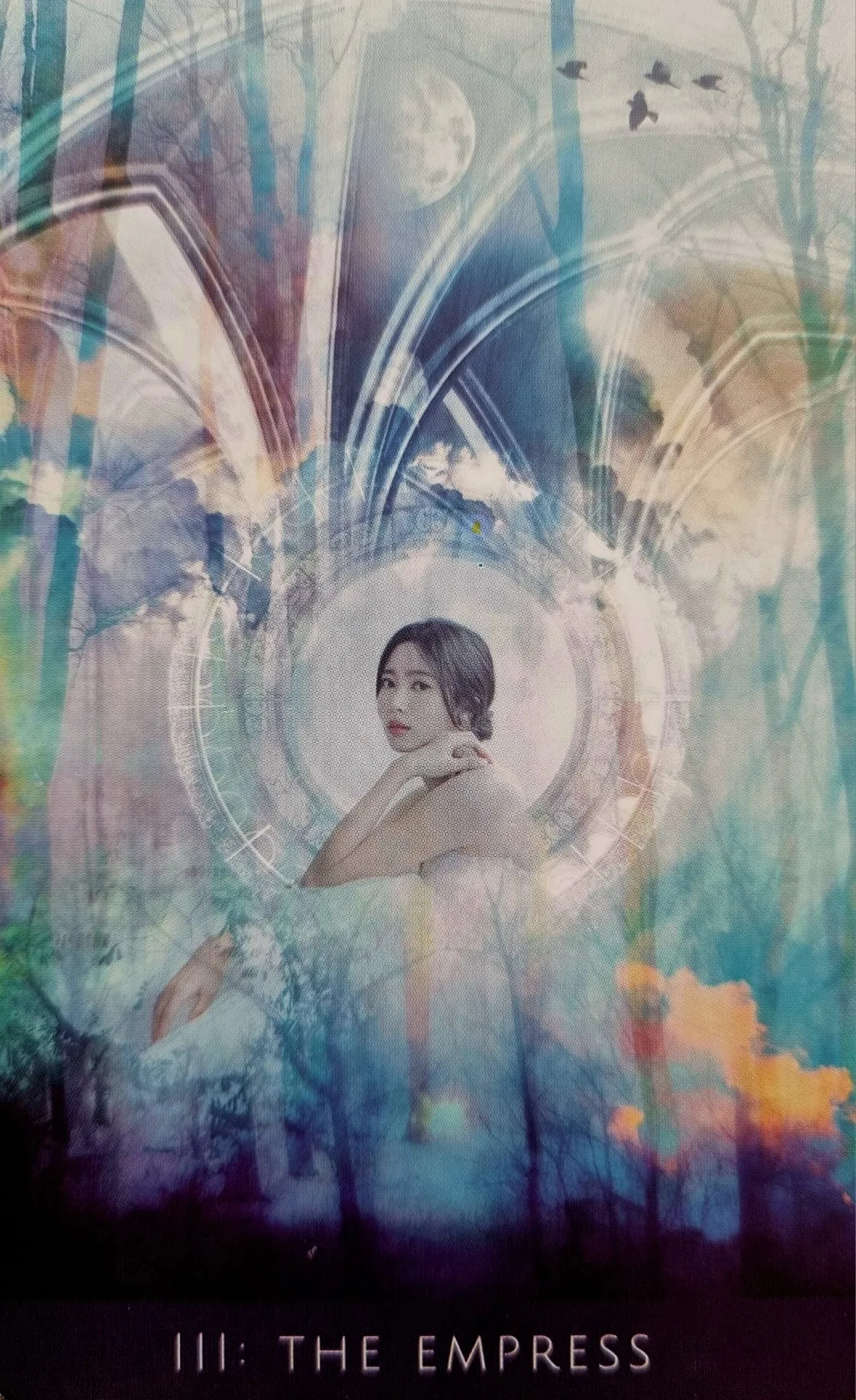 The Empress card from the Rooted Remembrance Tarot, a figure glancing back within a circle of light in an autumn forest, birds overhead