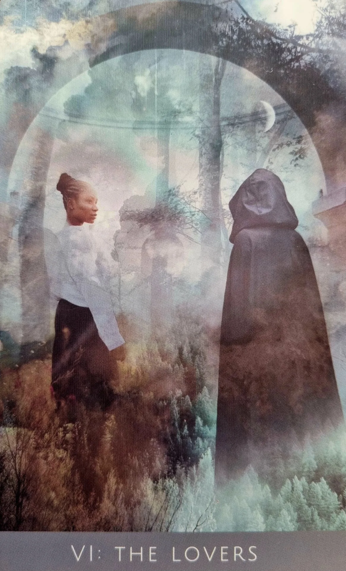 The Lovers card from the Rooted Remembrance Tarot, two hooded figures facing each other beneath an archway with a crescent moon