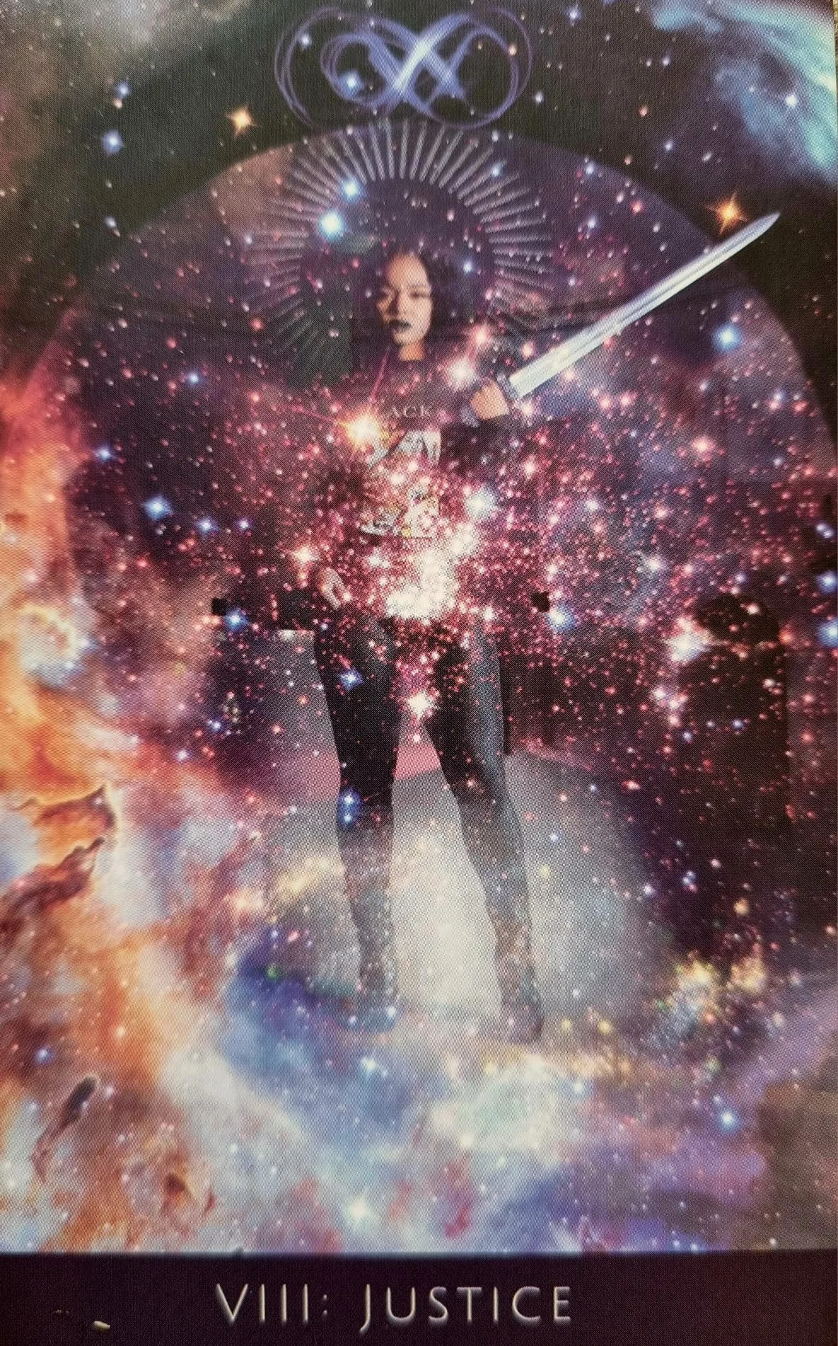 The Justice card from the Rooted Remembrance Tarot, a figure holding a sword aloft amid a starfield of pink and violet light