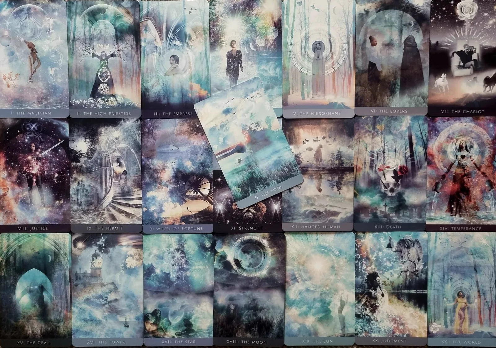 All twenty two Major Arcana cards of the Rooted Remembrance Tarot laid out in a grid with The Fool resting across the centre
