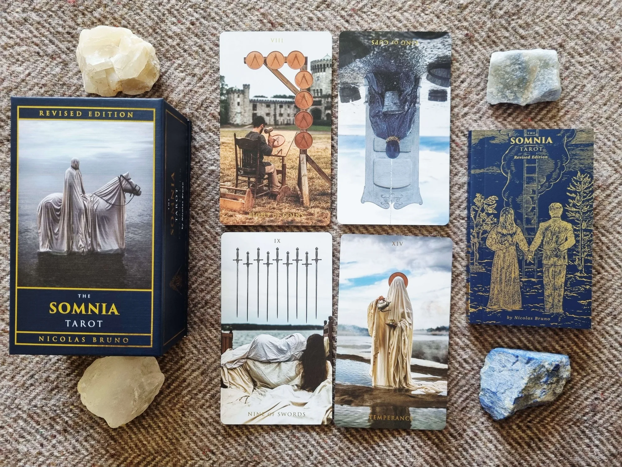 Four-card Johari Window spread from the Somnia Tarot: the Eight of Pentacles, the King of Cups reversed, the Nine of Swords and Temperance beside the deck box and crystals