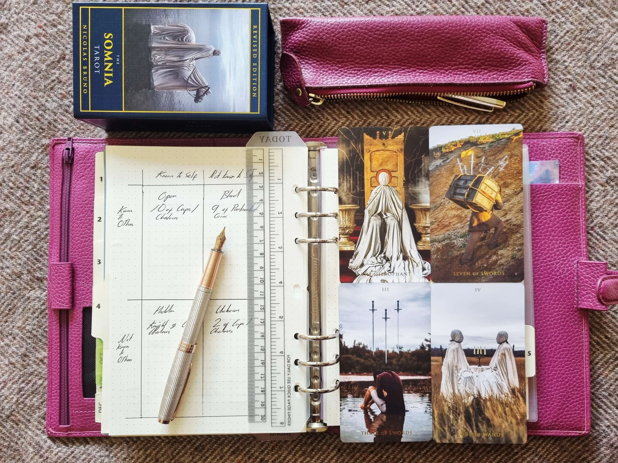 Johari Window journal page in a pink planner with a fountain pen, beside the Somnia Tarot box and four cards including the Seven of Swords