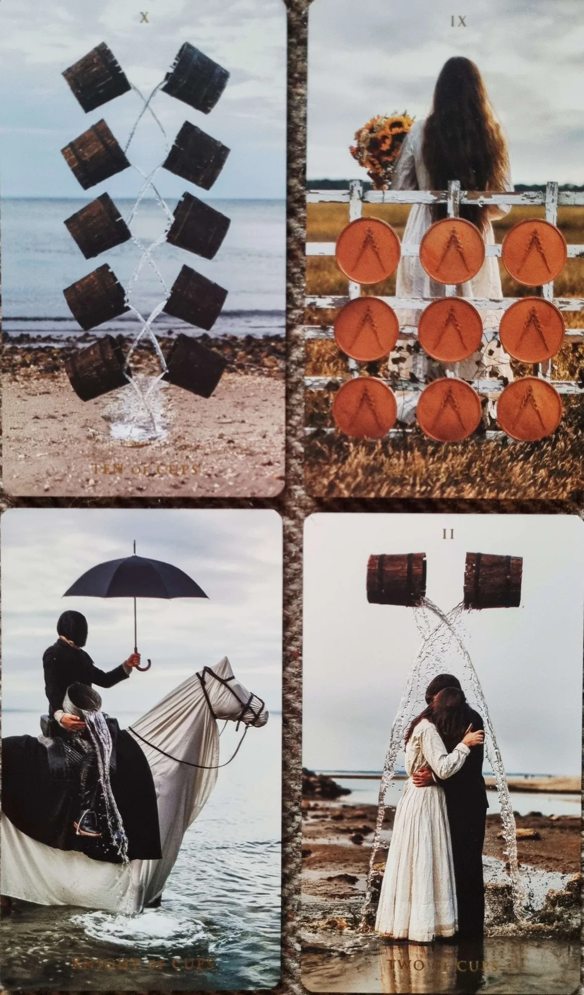 Four Somnia Tarot cards in a grid: the Ten of Cups, the Nine of Pentacles, the Knight of Cups under a black umbrella and the Two of Cups