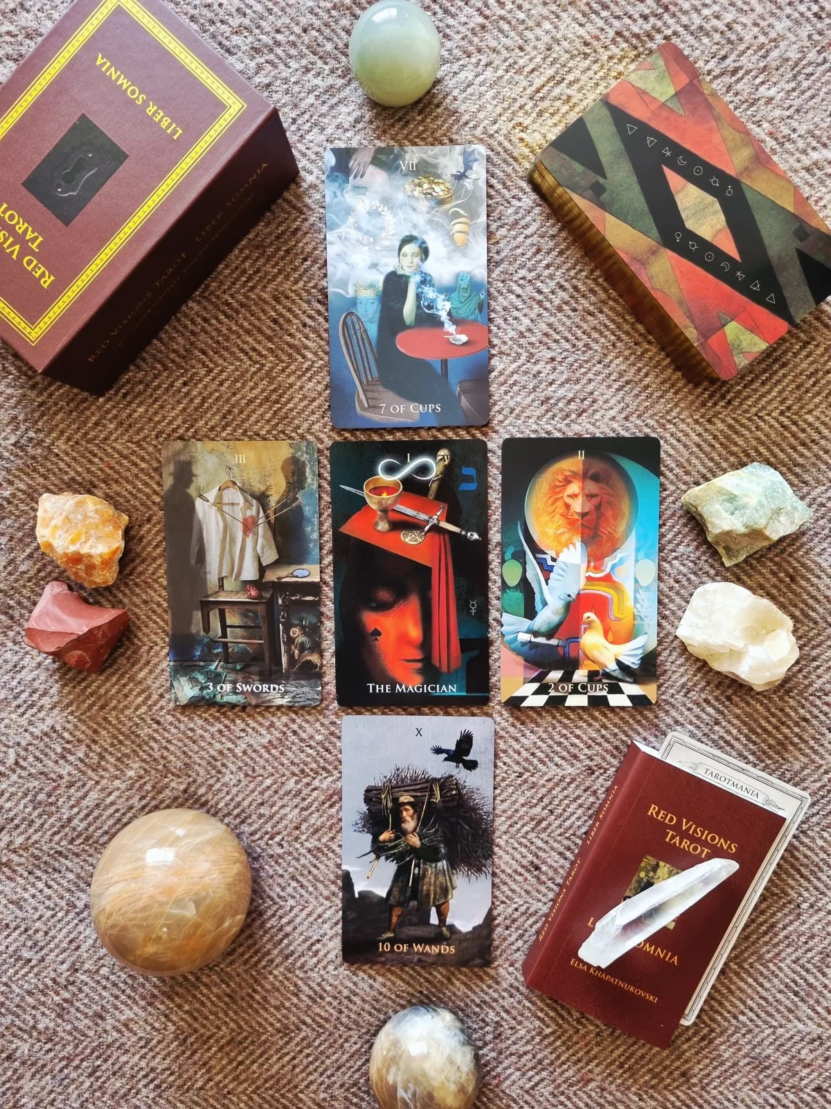 Major Arcana cards from Liber Somnia Red Visions Tarot spread beside the red box and crystals