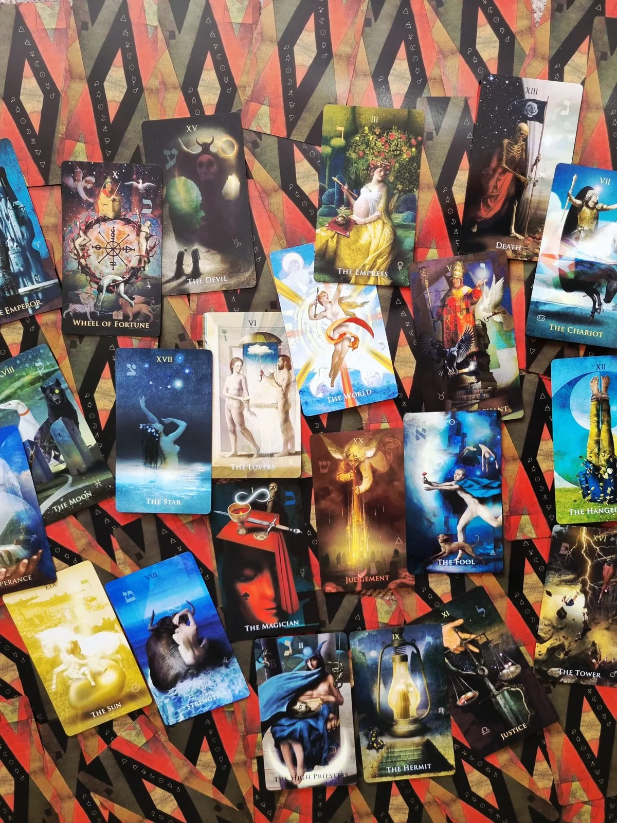 All 78 cards of Liber Somnia Red Visions Tarot laid out on the red and black card back pattern