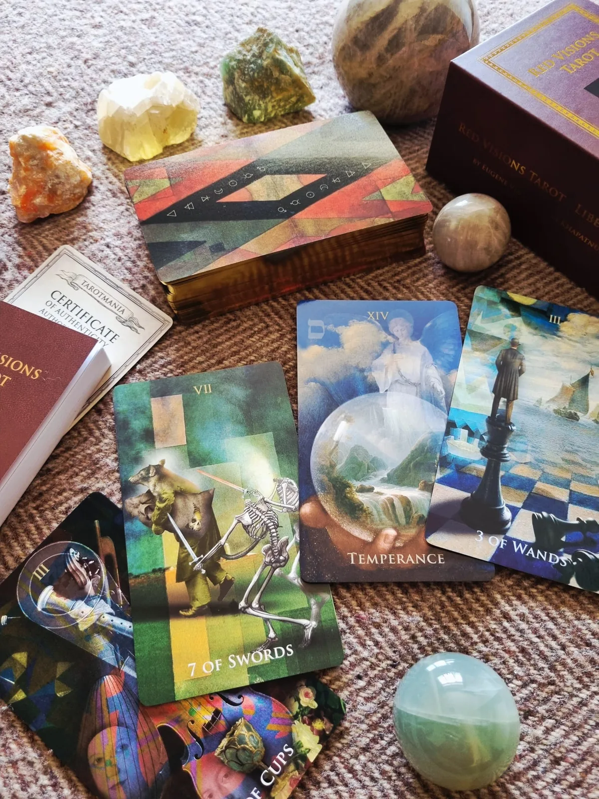 Liber Somnia Red Visions Tarot cards fanned in front of the red presentation box