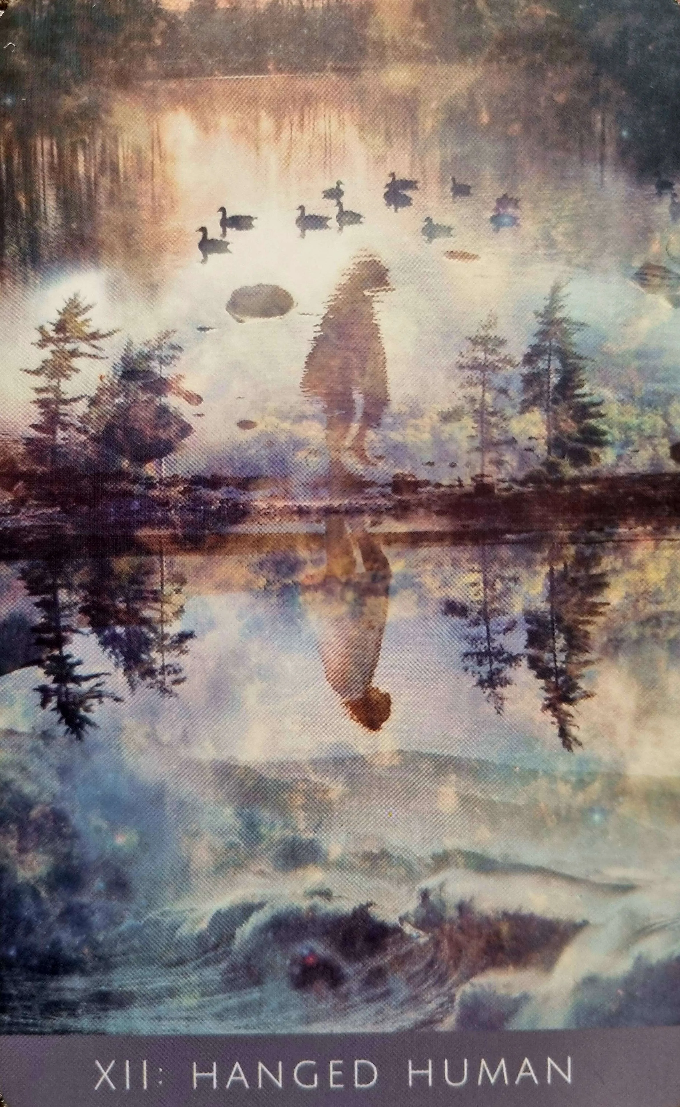Hanged Human tarot card reflected over a misty lake with wild geese