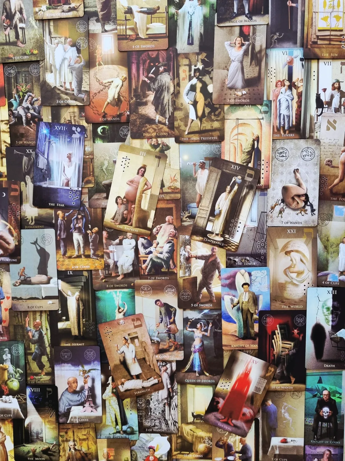 All 78 cards of The Madhouse Tarot laid out face up showing the surreal hand-drawn artwork