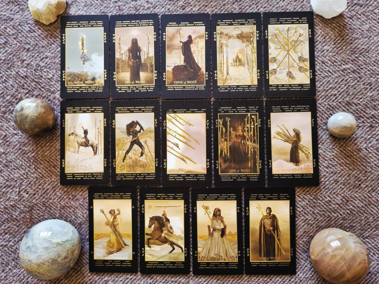 The complete suit of Wands from the Lucid Dreams Tarot, fourteen cards laid out in rows with crystal spheres
