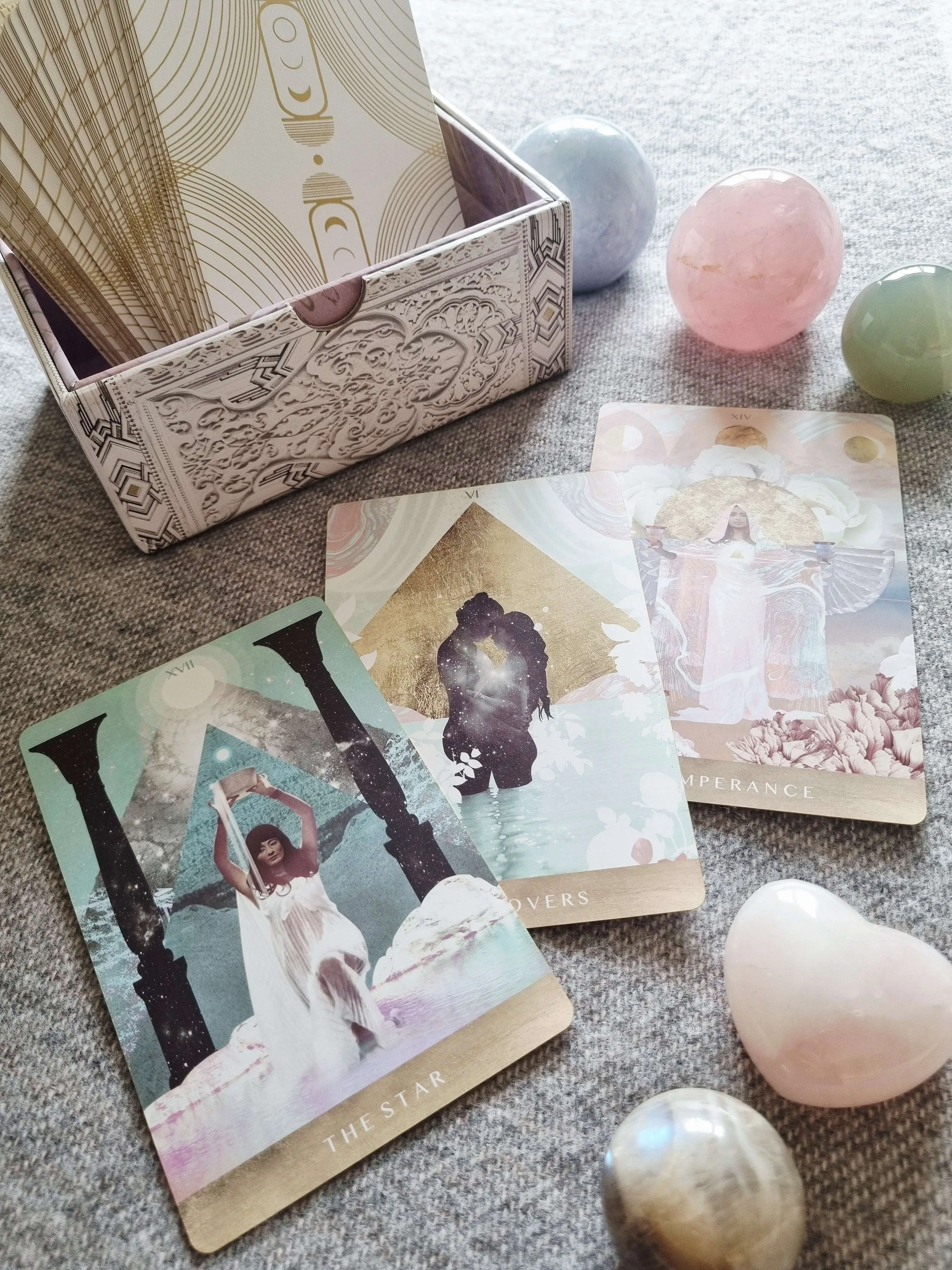 The Moonchild Tarot White and Gold Edition box open beside The Star, The Lovers and Temperance cards