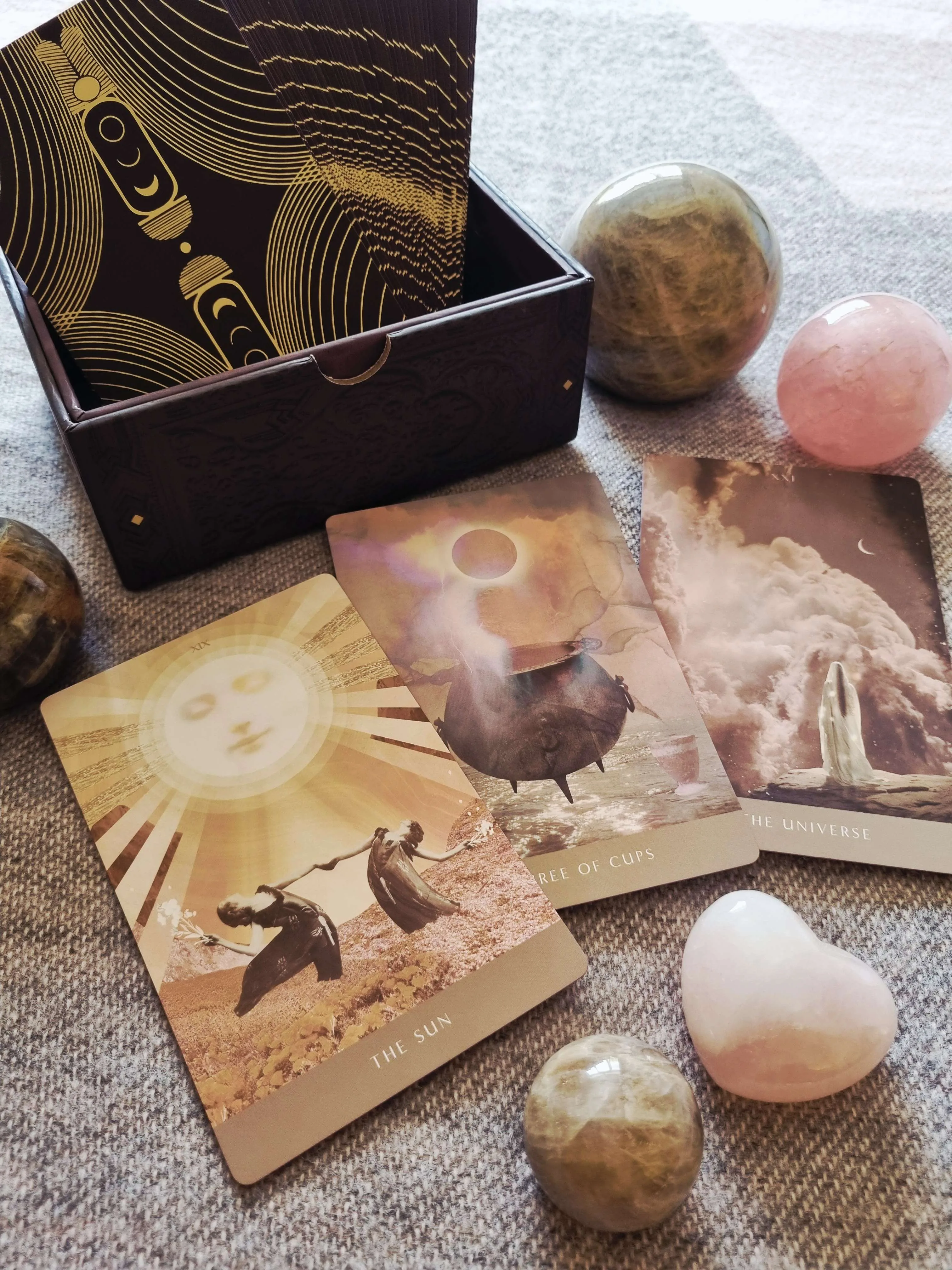 The Moonchild Tarot Shadow Work Edition box beside The Sun, Three of Cups and The Universe cards
