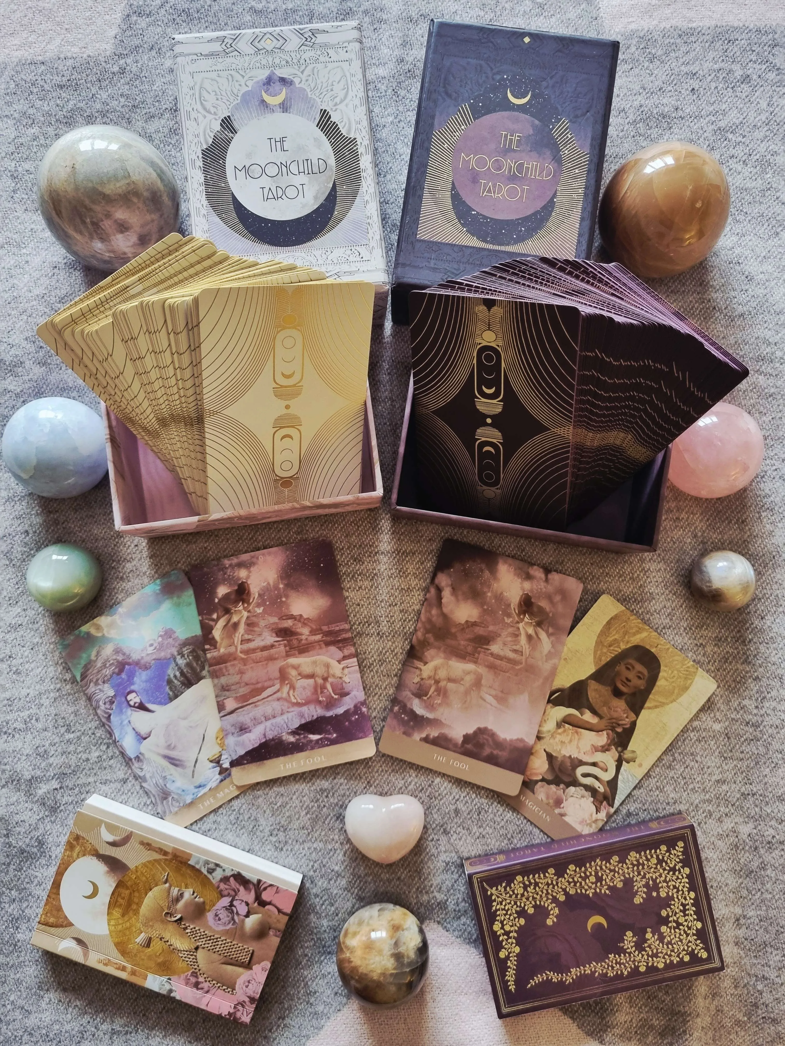 The Moonchild Tarot White and Gold Edition and Shadow Work Edition boxes and decks side by side