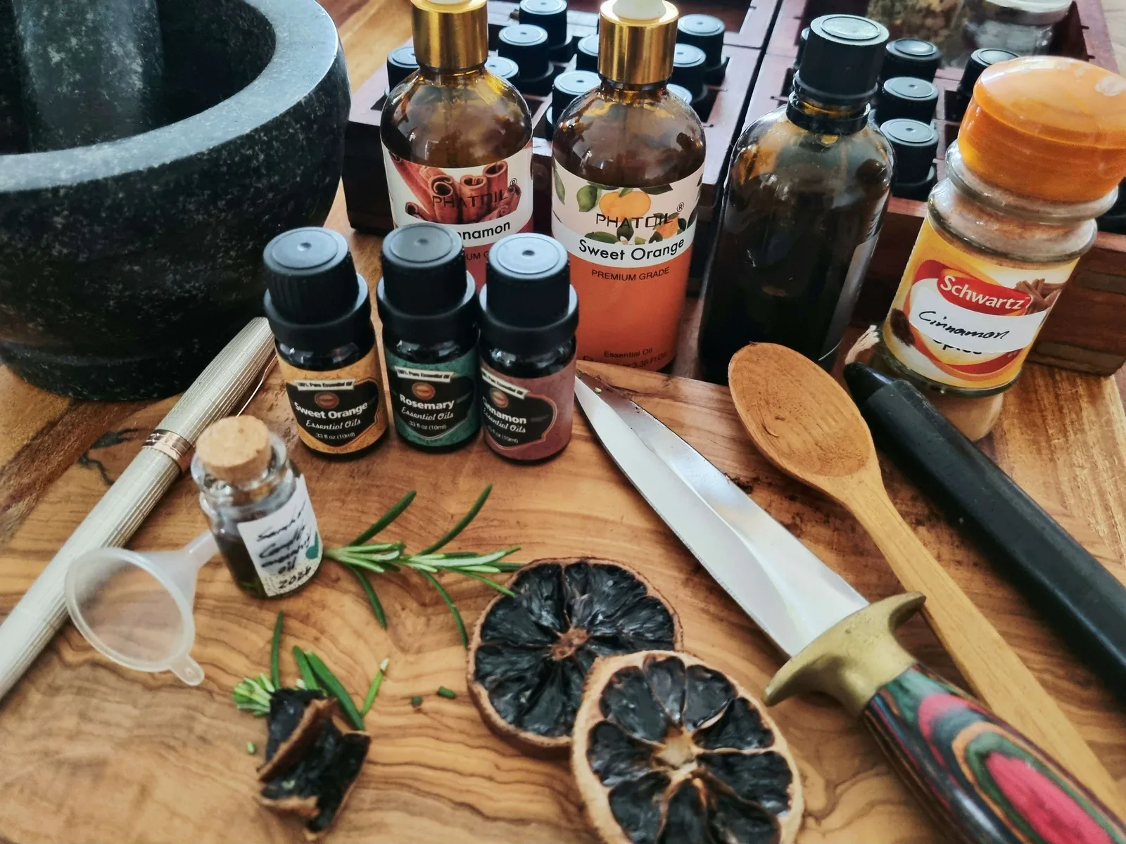 rosemary, sweet orange and cinnamon essential oils with dried orange for Samhain candle anointing oil