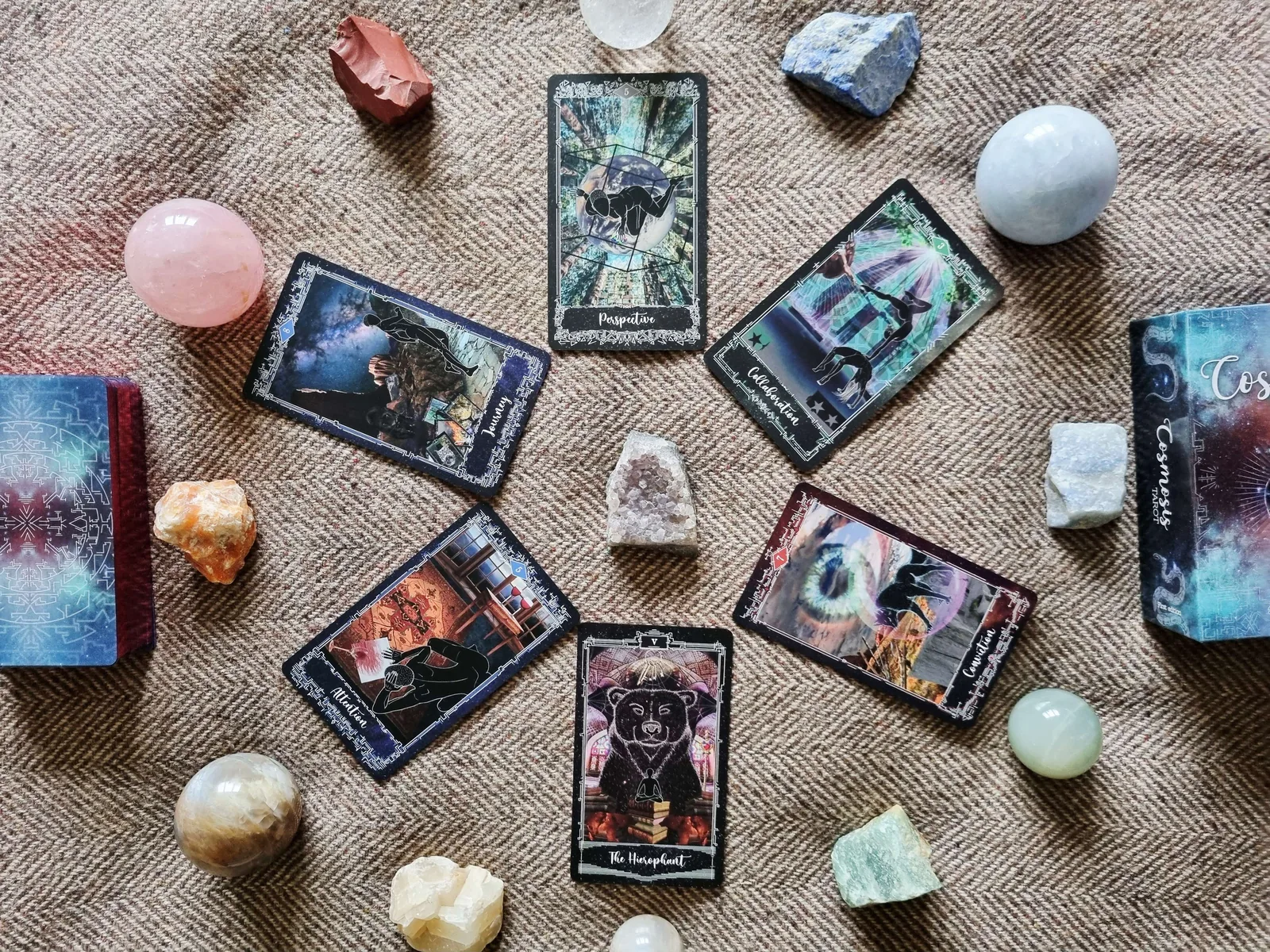 six Cosmosis Tarot cards turned over beside crystals for a final Samhain reflection