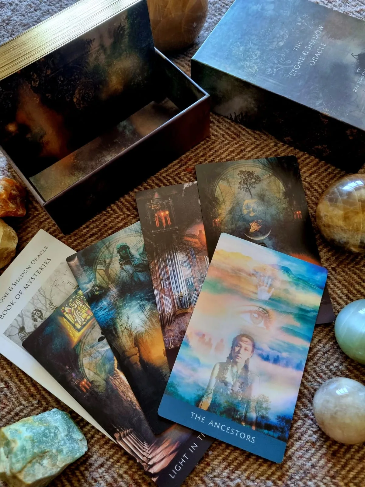 Open Stone and Shadow Oracle box with Book of Mysteries guidebook and The Ancestors card