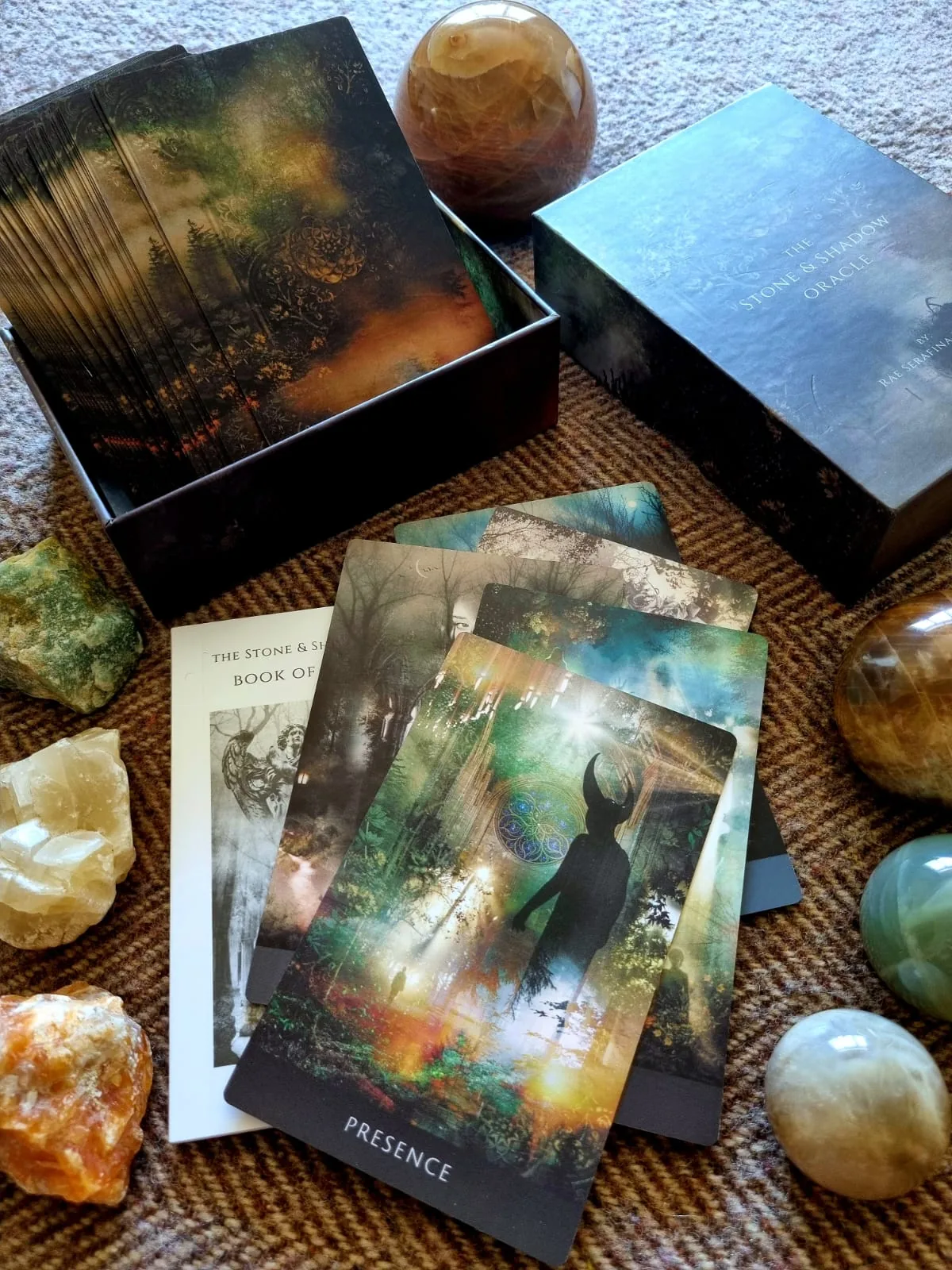 Fanned Stone and Shadow Oracle deck with The Alchemist card and crystal spheres