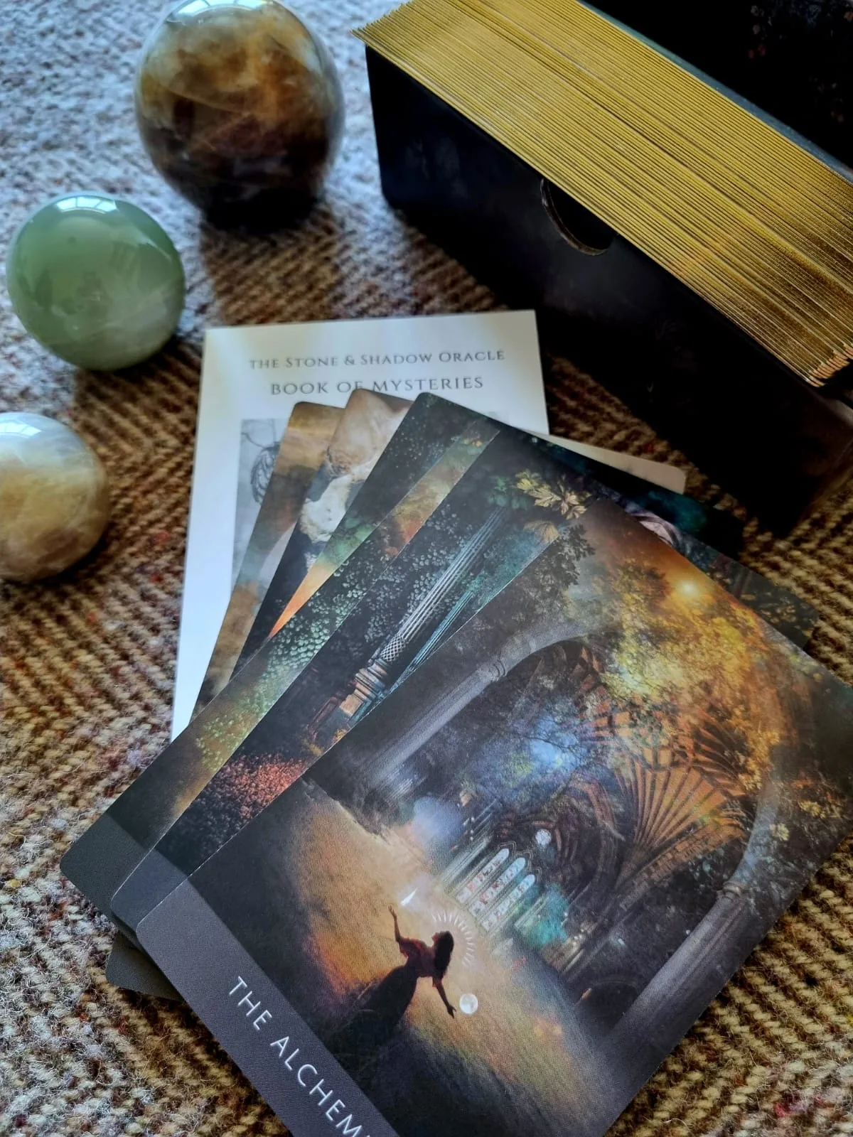 Stone and Shadow Oracle guidebook open on a poem page with Thin Place and Underworld cards