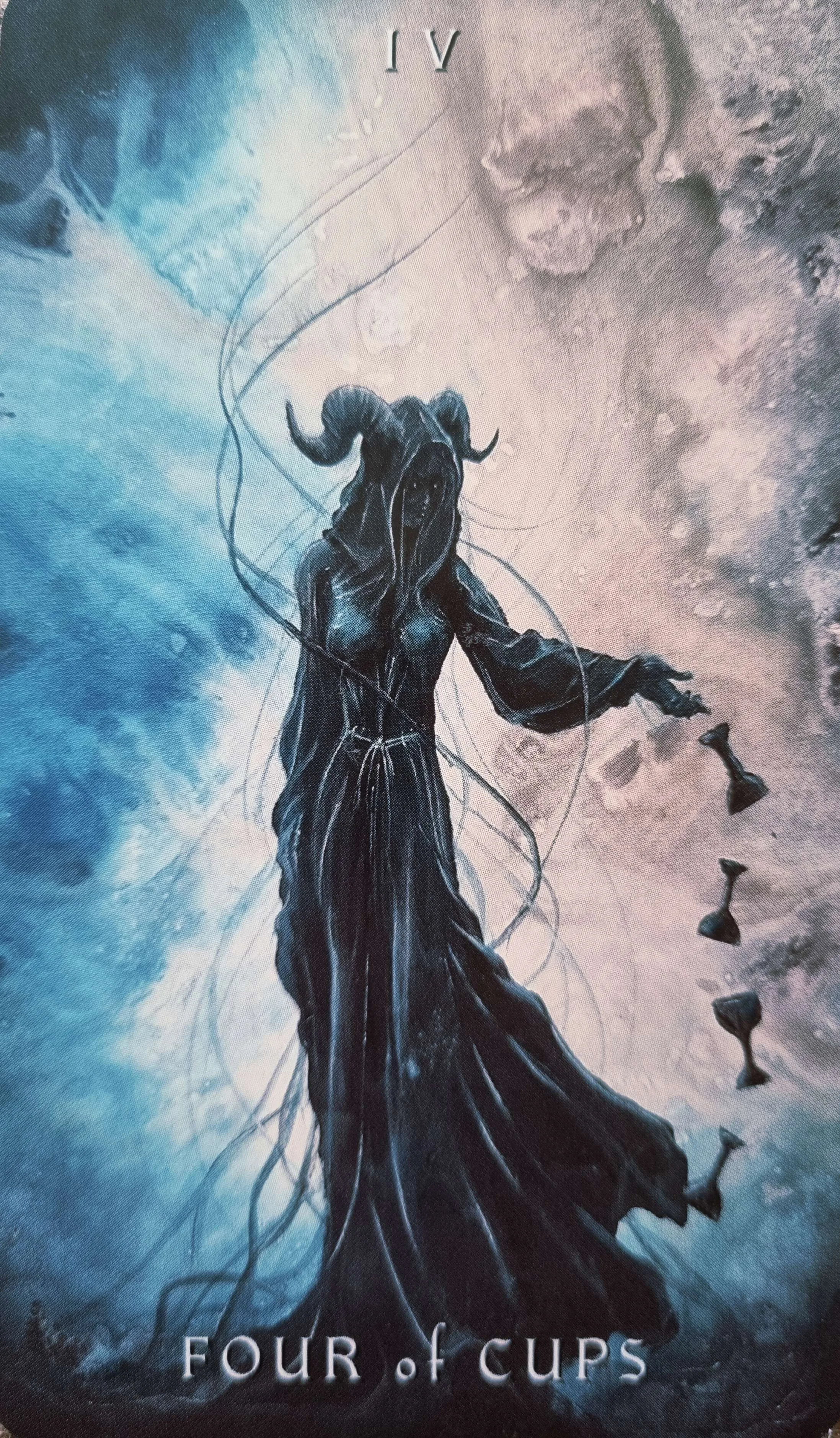 Four of Cups tarot card, a horned figure turning away from four floating cups