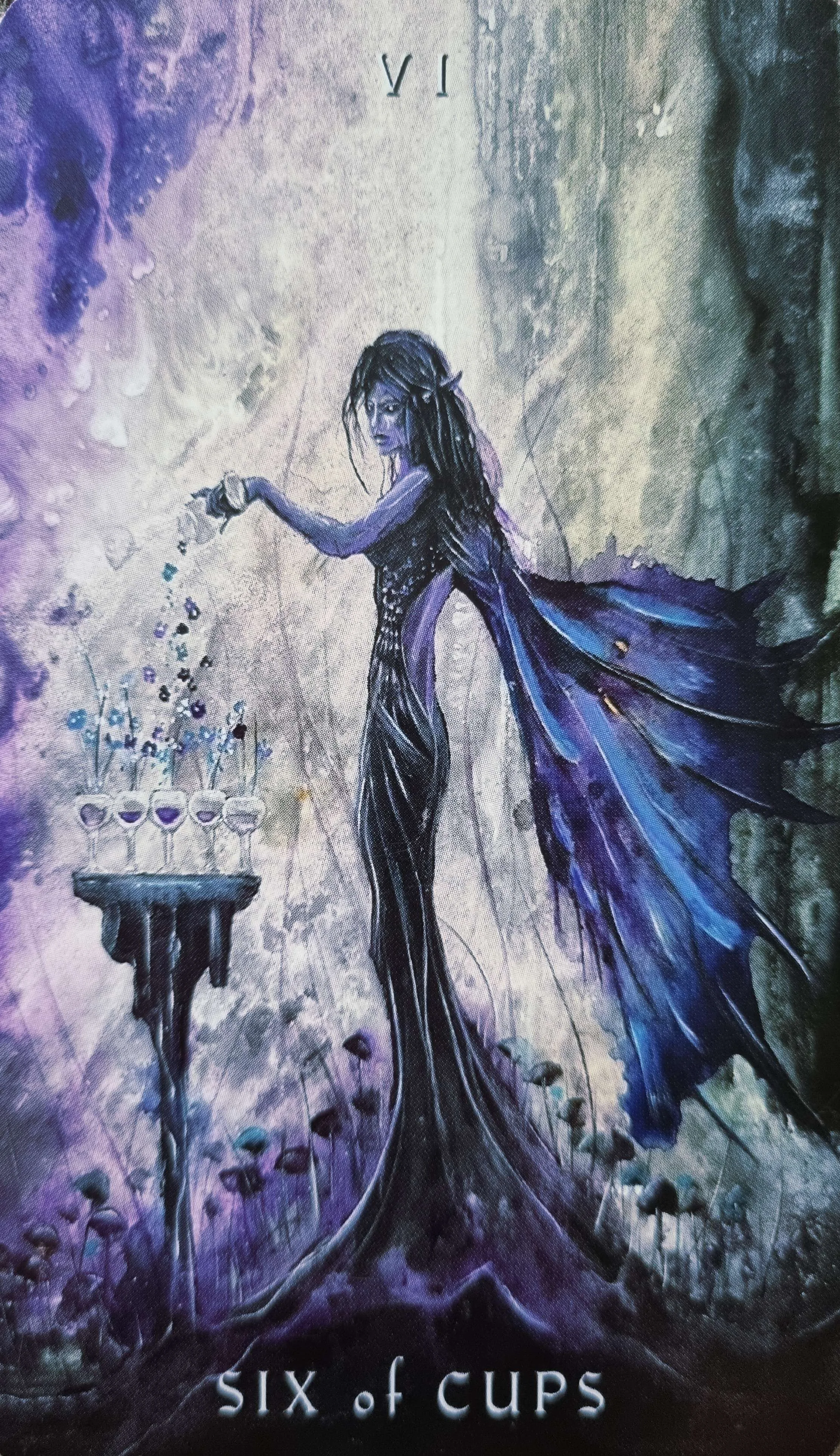 Six of Cups tarot card, a winged figure pouring flowers into a row of cups