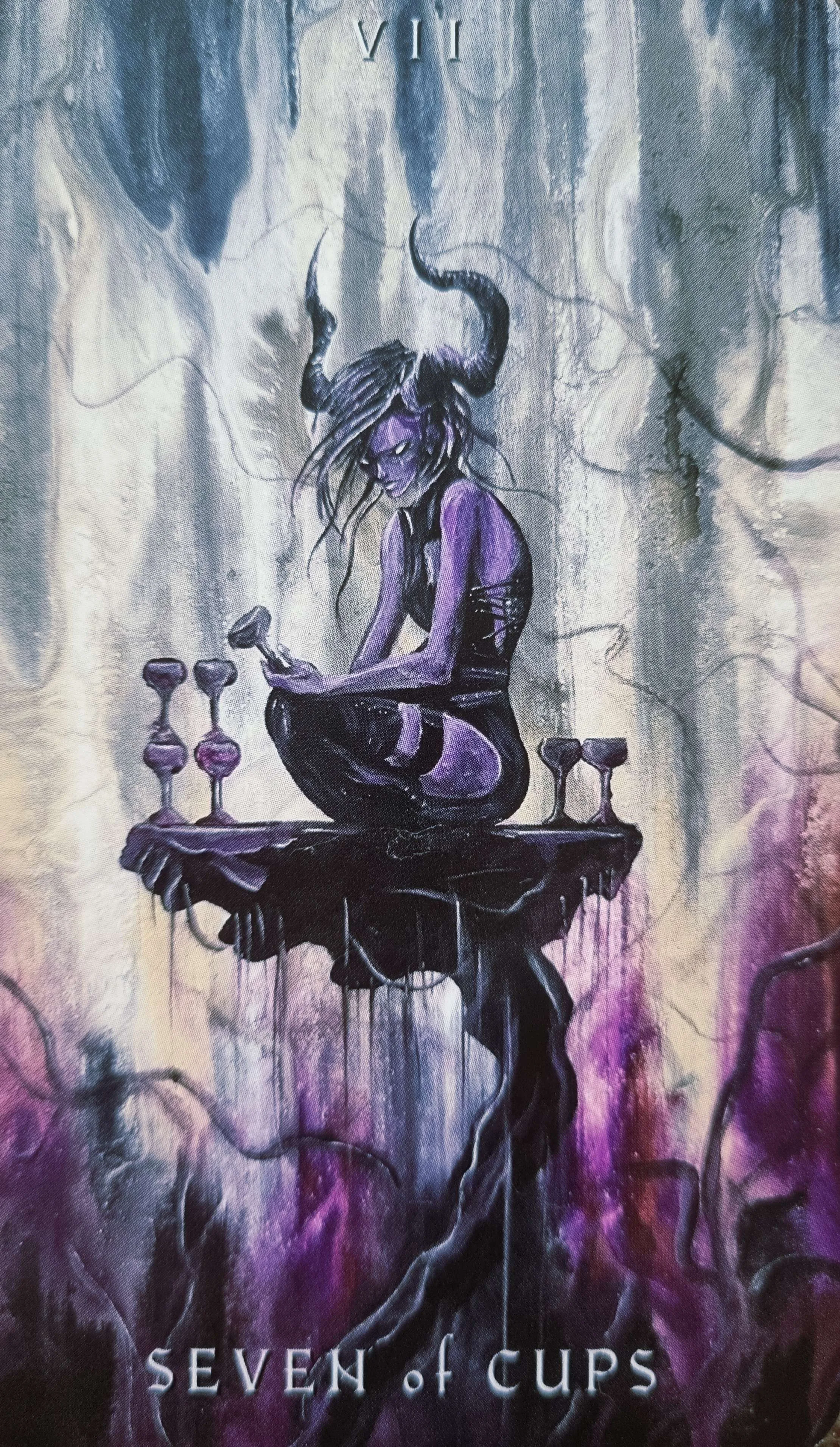 Seven of Cups tarot card, a horned figure surrounded by cups on a floating table