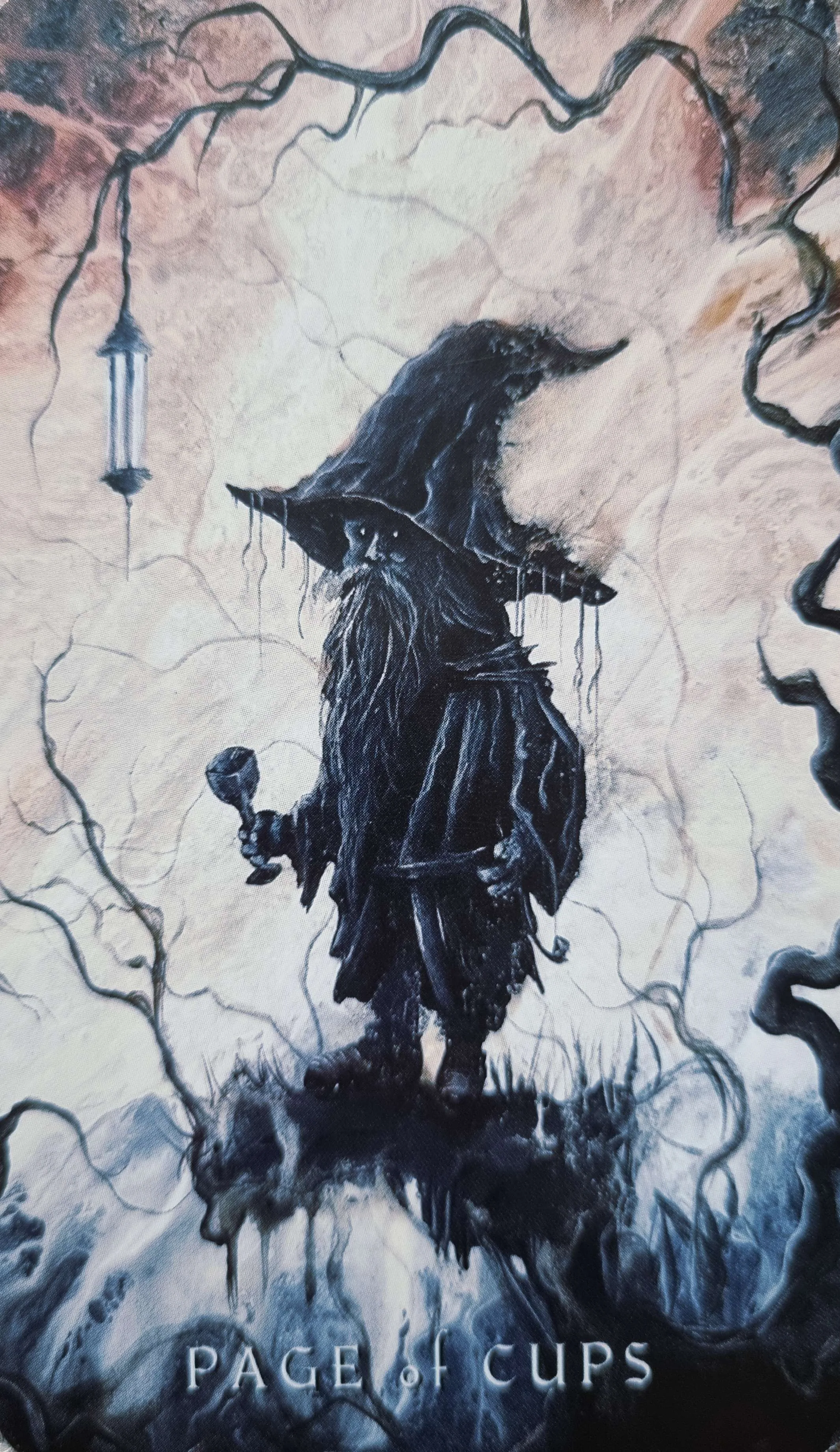 Page of Cups tarot card, a robed figure in a tall hat holding a cup beneath a lantern