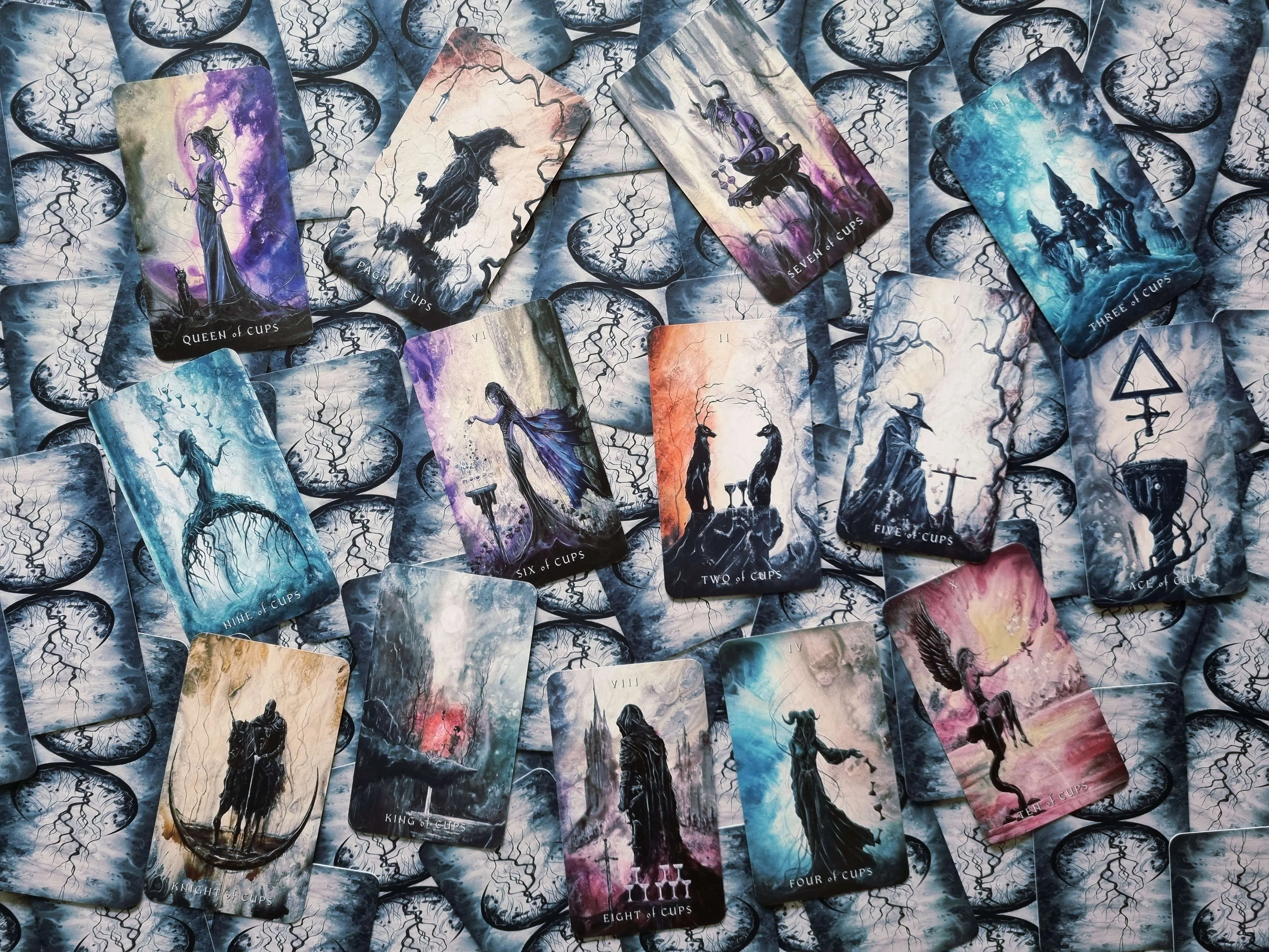 Suit of Cups tarot cards from The Dark Fantasy Tarot scattered together