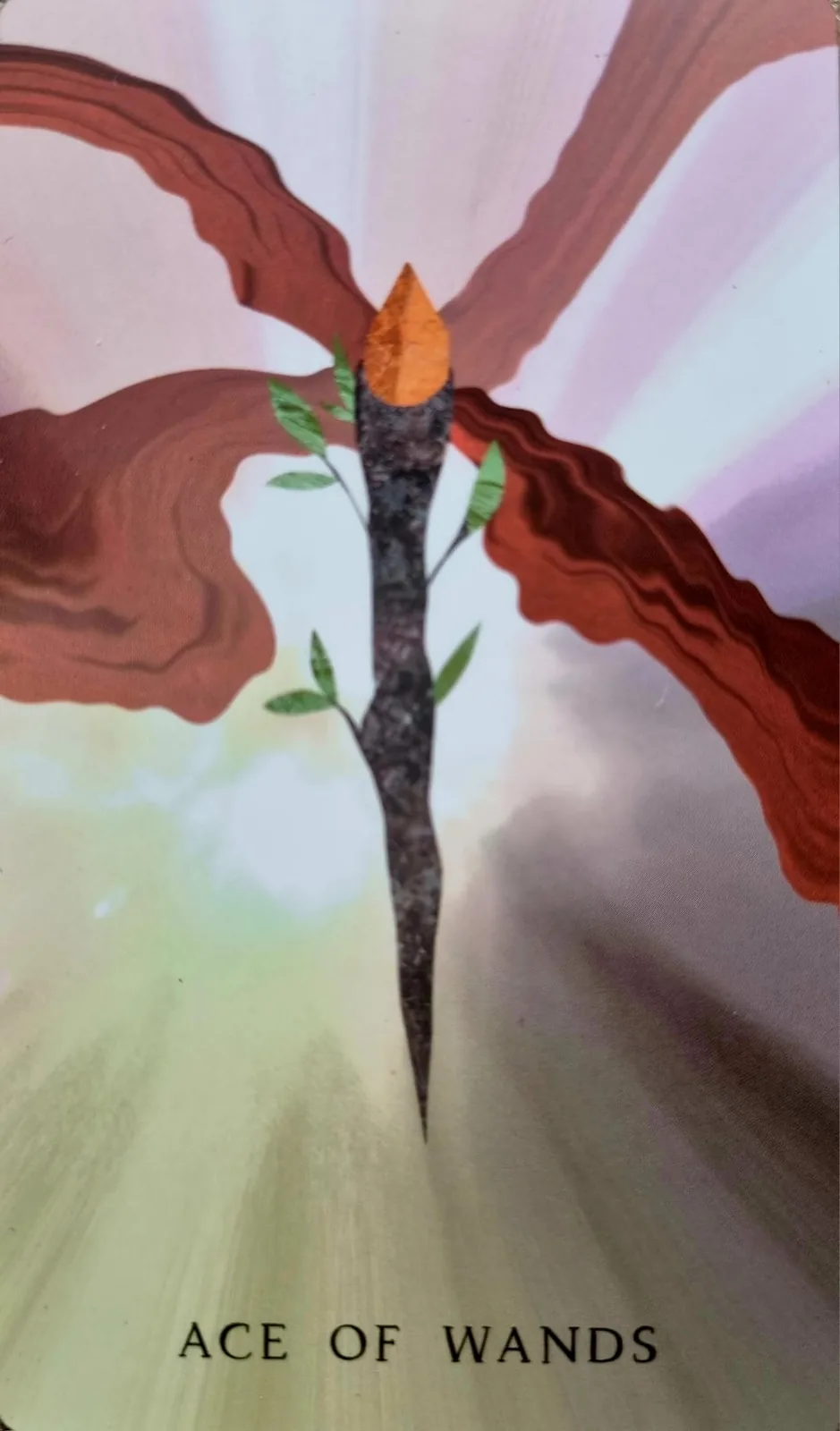 Ace of Wands tarot card, a single flaming wand against rays of light