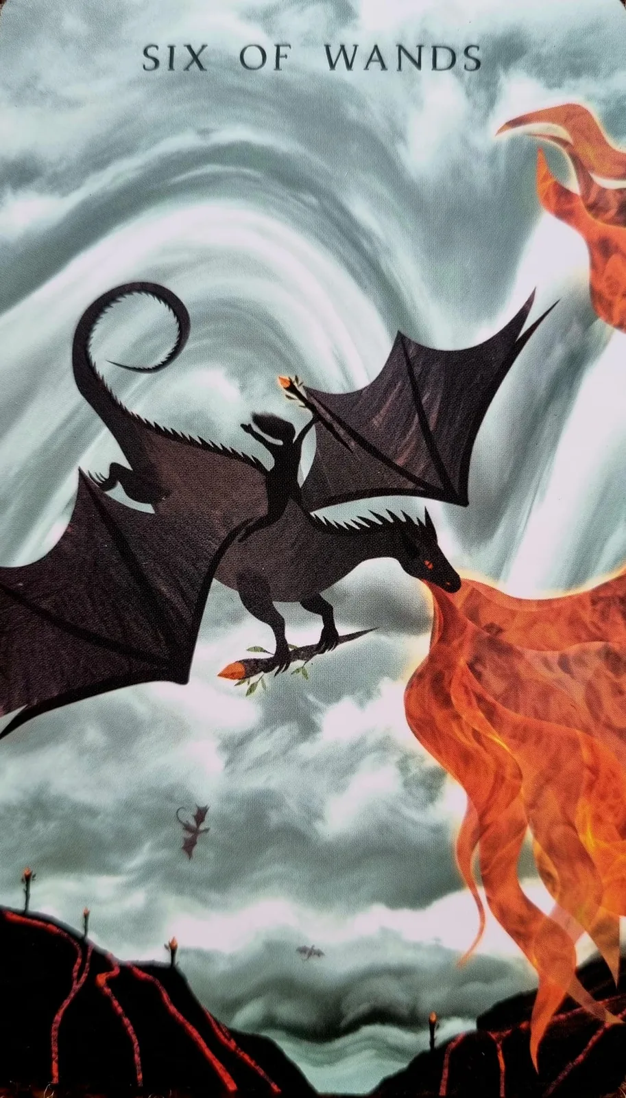 Six of Wands tarot card, a rider on a dragon against a swirling fiery sky