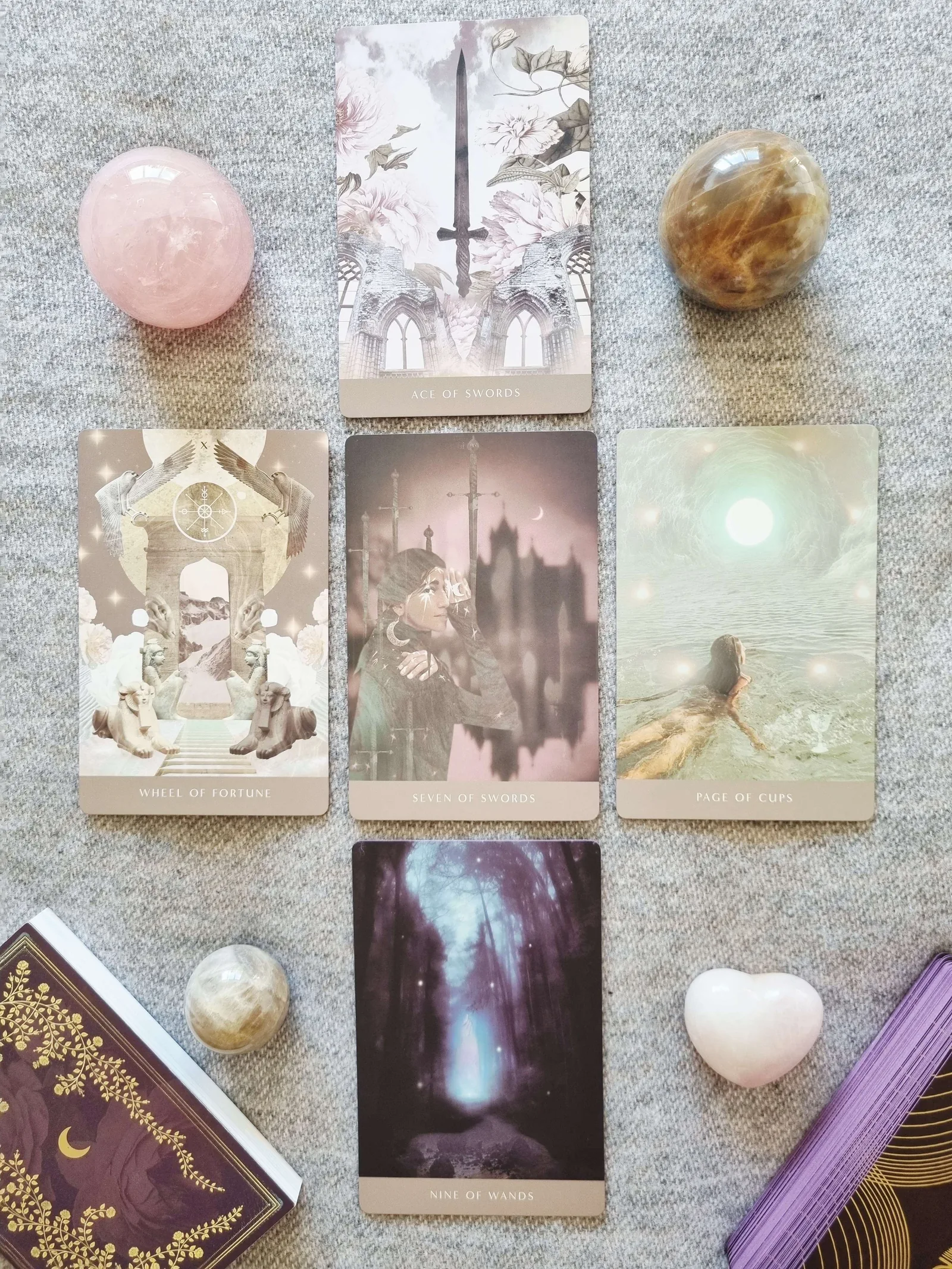 Five card tarot reading from the Moonchild Tarot Shadow Work Edition: Seven of Swords, Wheel of Fortune, Nine of Wands, Ace of Swords and Page of Cups