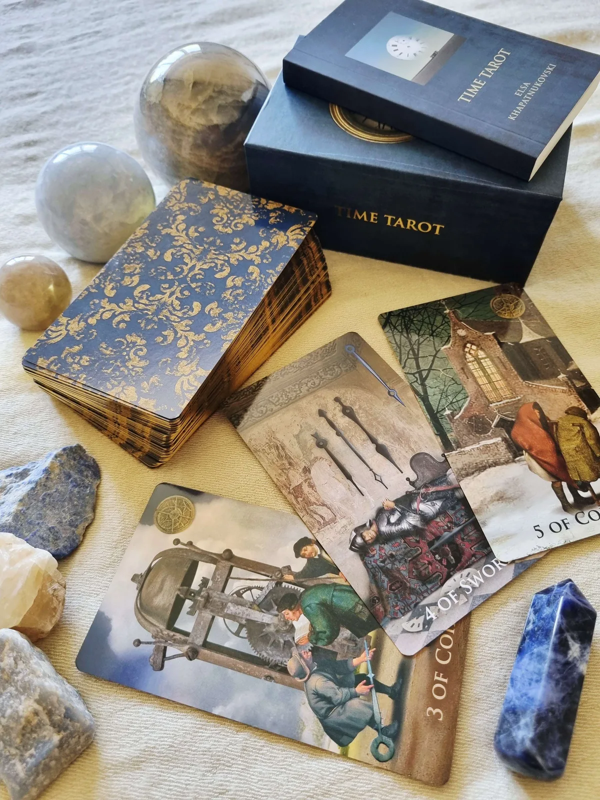 Time Tarot cards showing Swords, Coins and Cups laid on the blue magnetic box