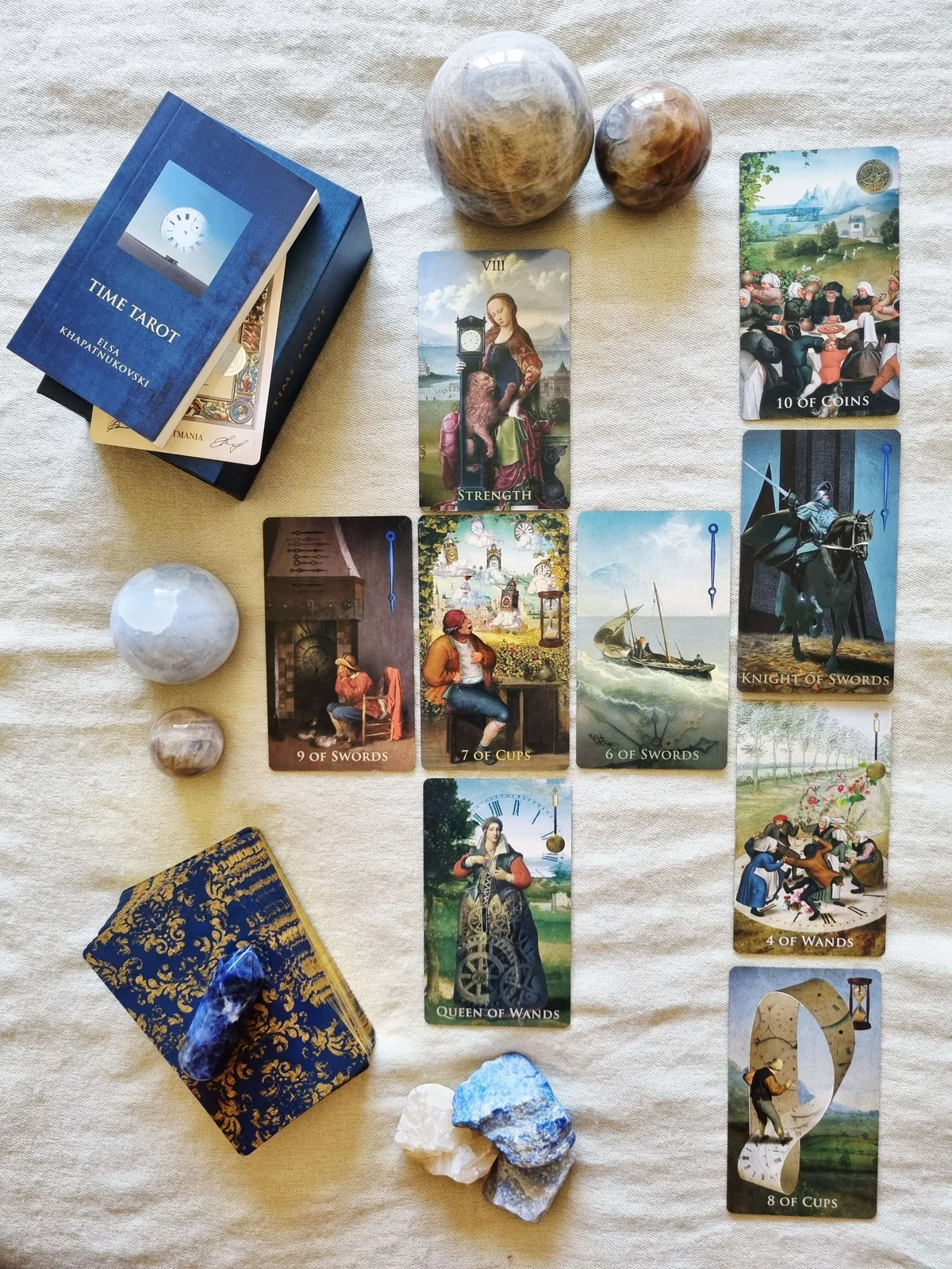 Time Tarot cards laid out in columns beside the companion book, box and deck