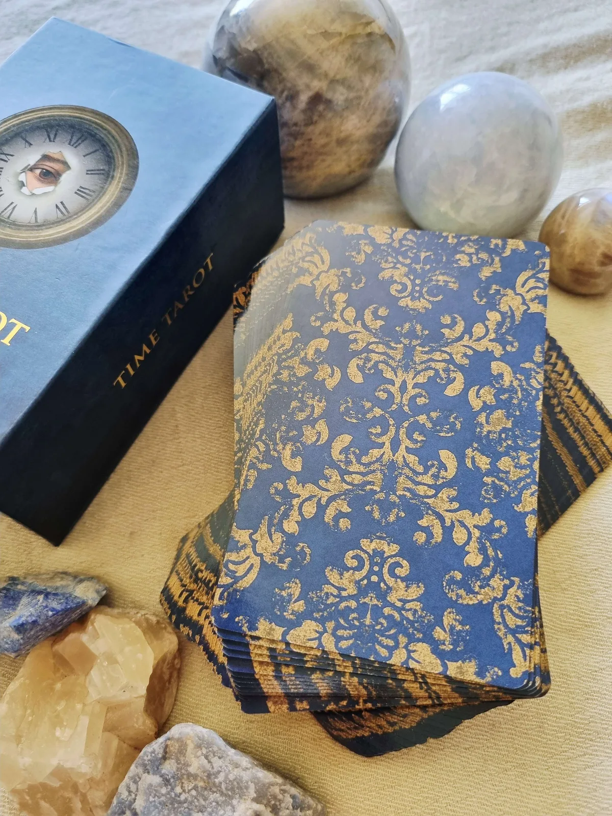 Time Tarot blue and gold card backs resting against the magnetic box